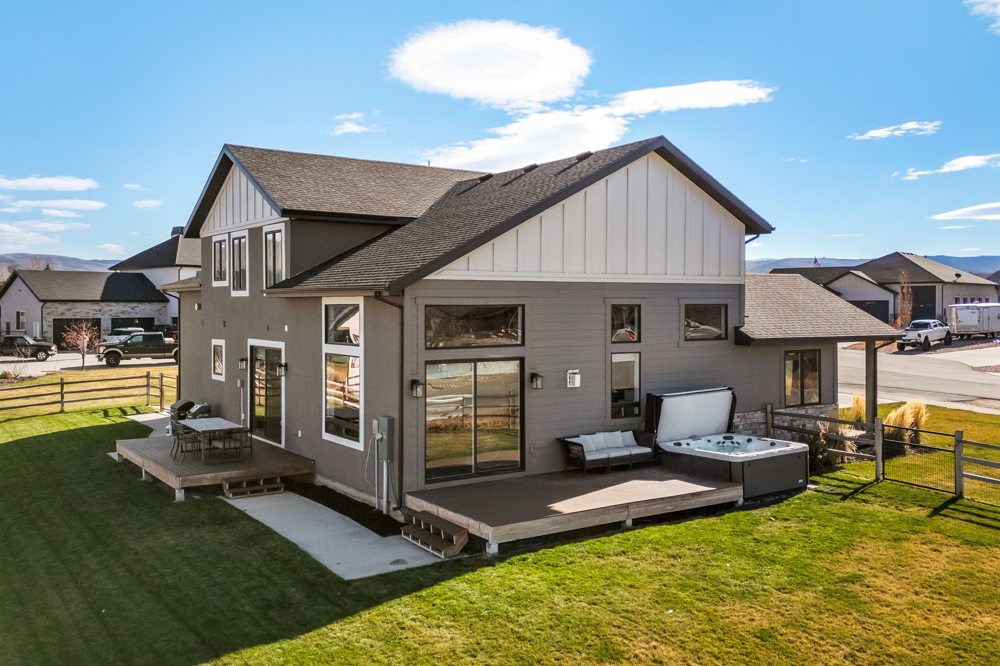 Expansive rear elevation featuring multiple outdoor living spaces