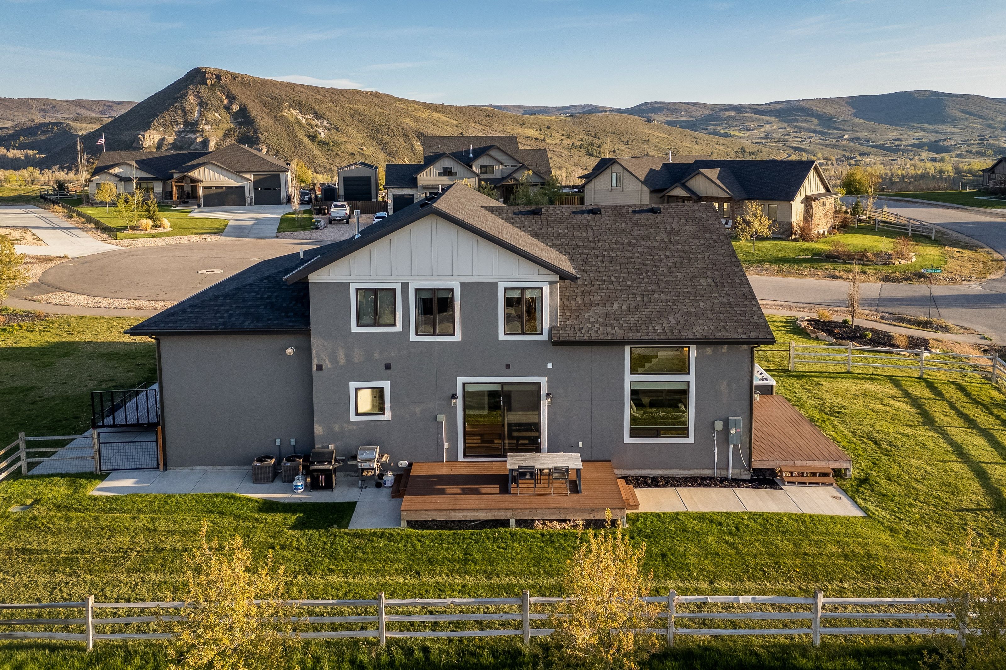 Contemporary two-story residence featuring a gray exterior with white trim