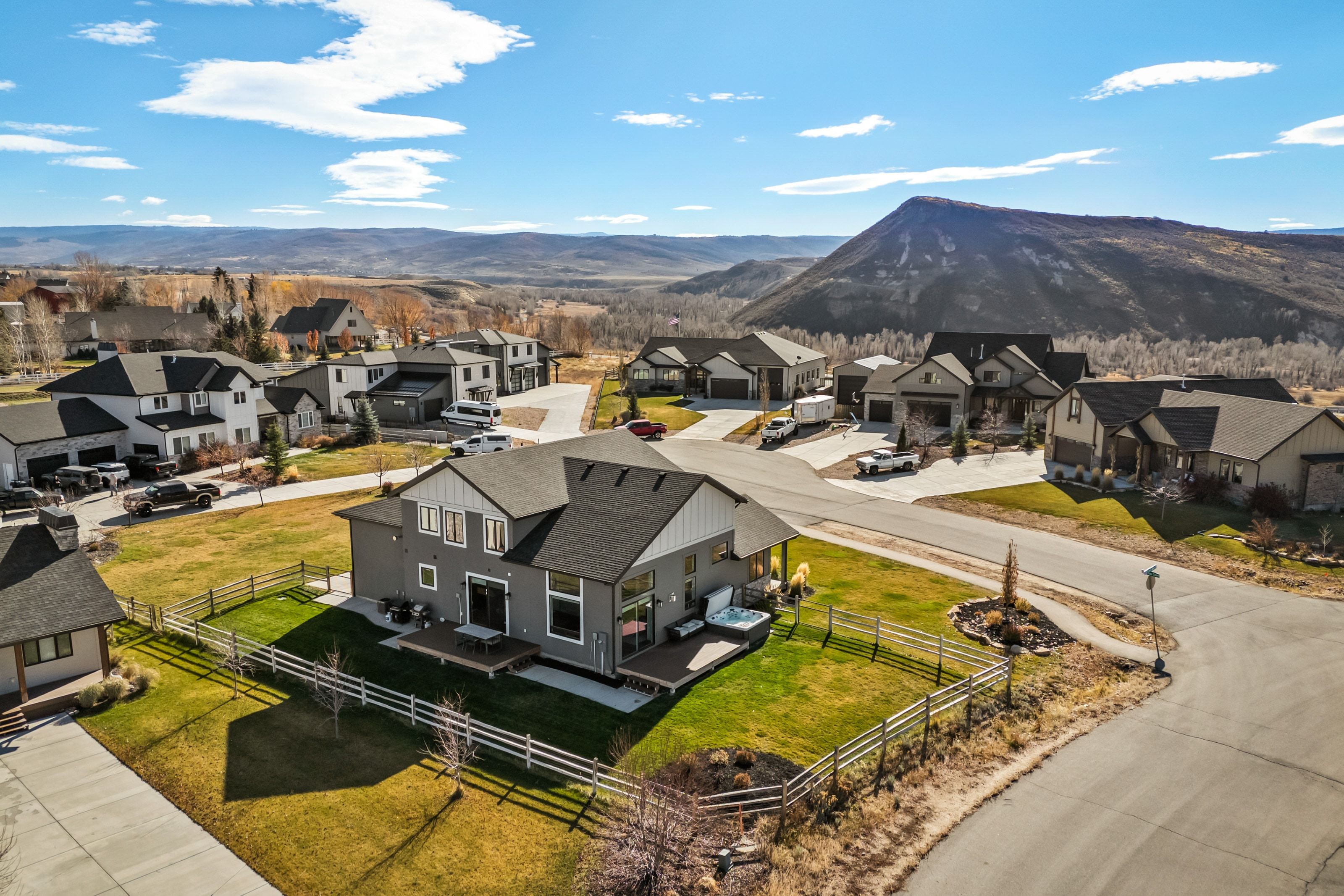 Contemporary residence with a dark gray exterior, white trim, and a prominent gable roof