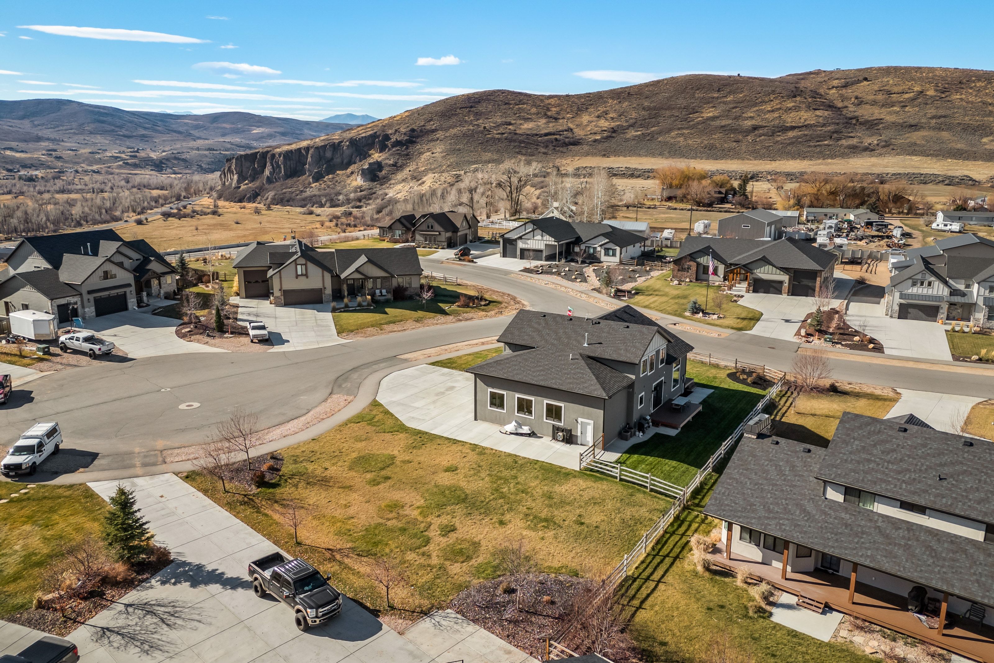 Residential neighborhood featuring contemporary homes with dark-toned siding and roofing
