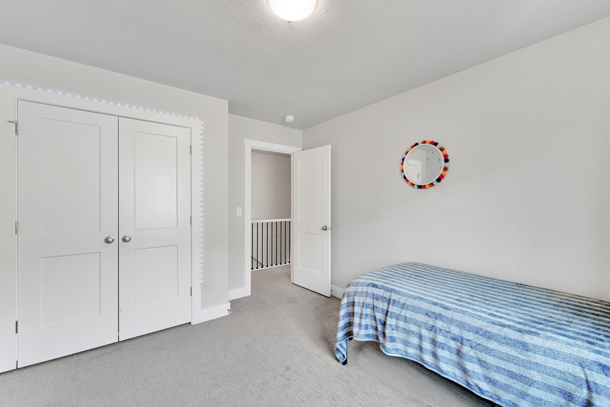 Interior space featuring light gray walls, light carpet flooring, and white trim