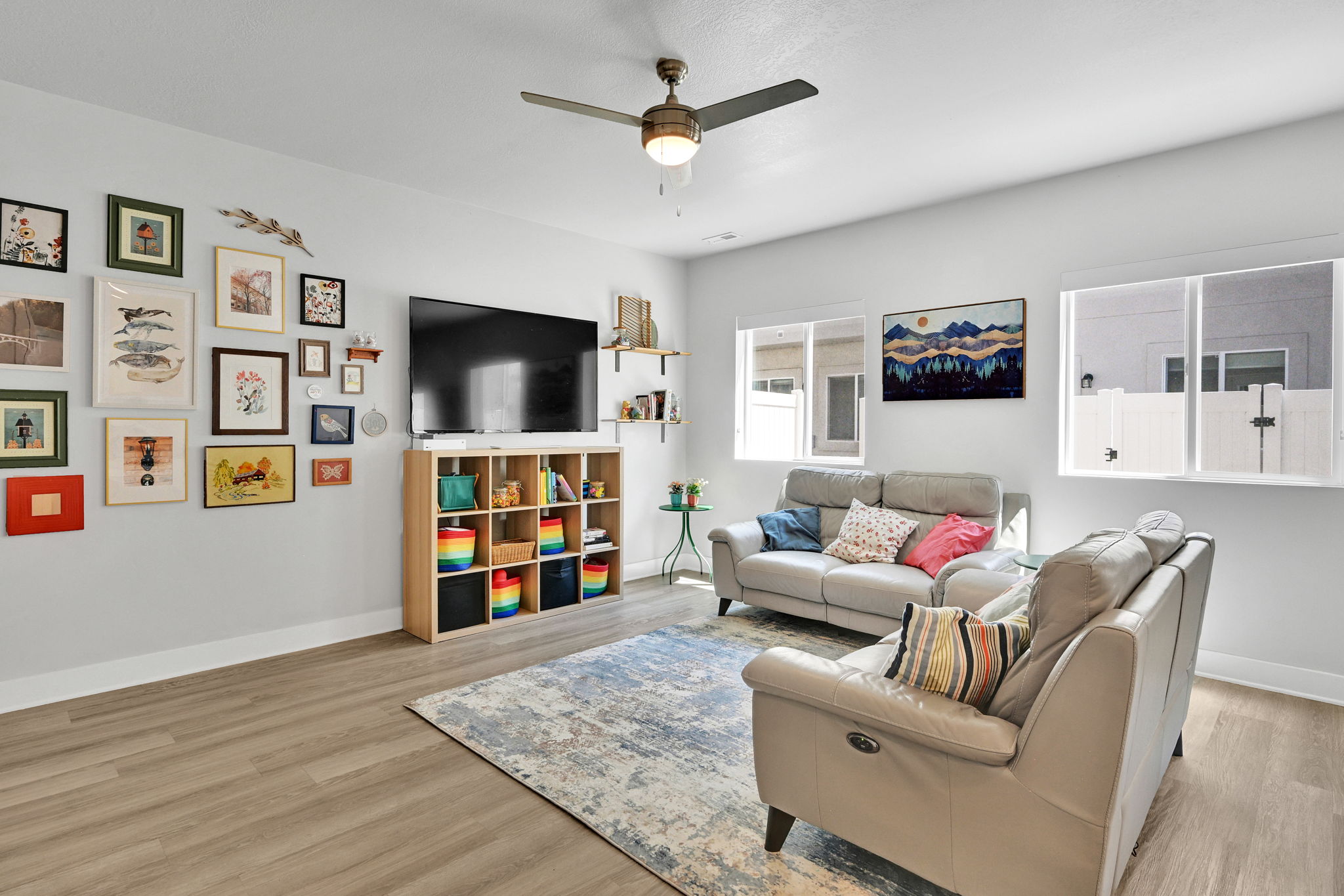 Spacious room featuring wood-finish flooring, white baseboards, and light-colored walls