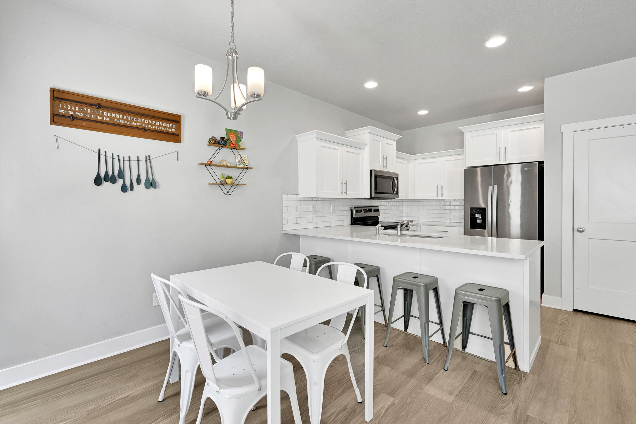 Bright kitchen featuring white cabinetry, stainless steel appliances, and a subway tile backsplash
