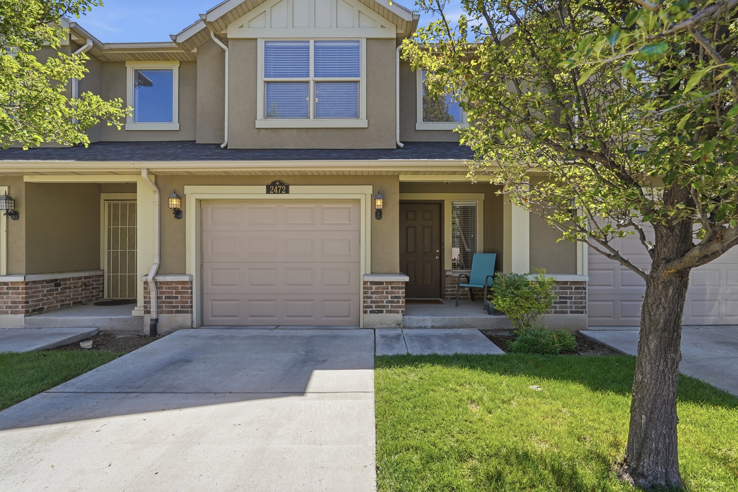 Exterior facade featuring a single-car garage, brick accents, and a covered entryway