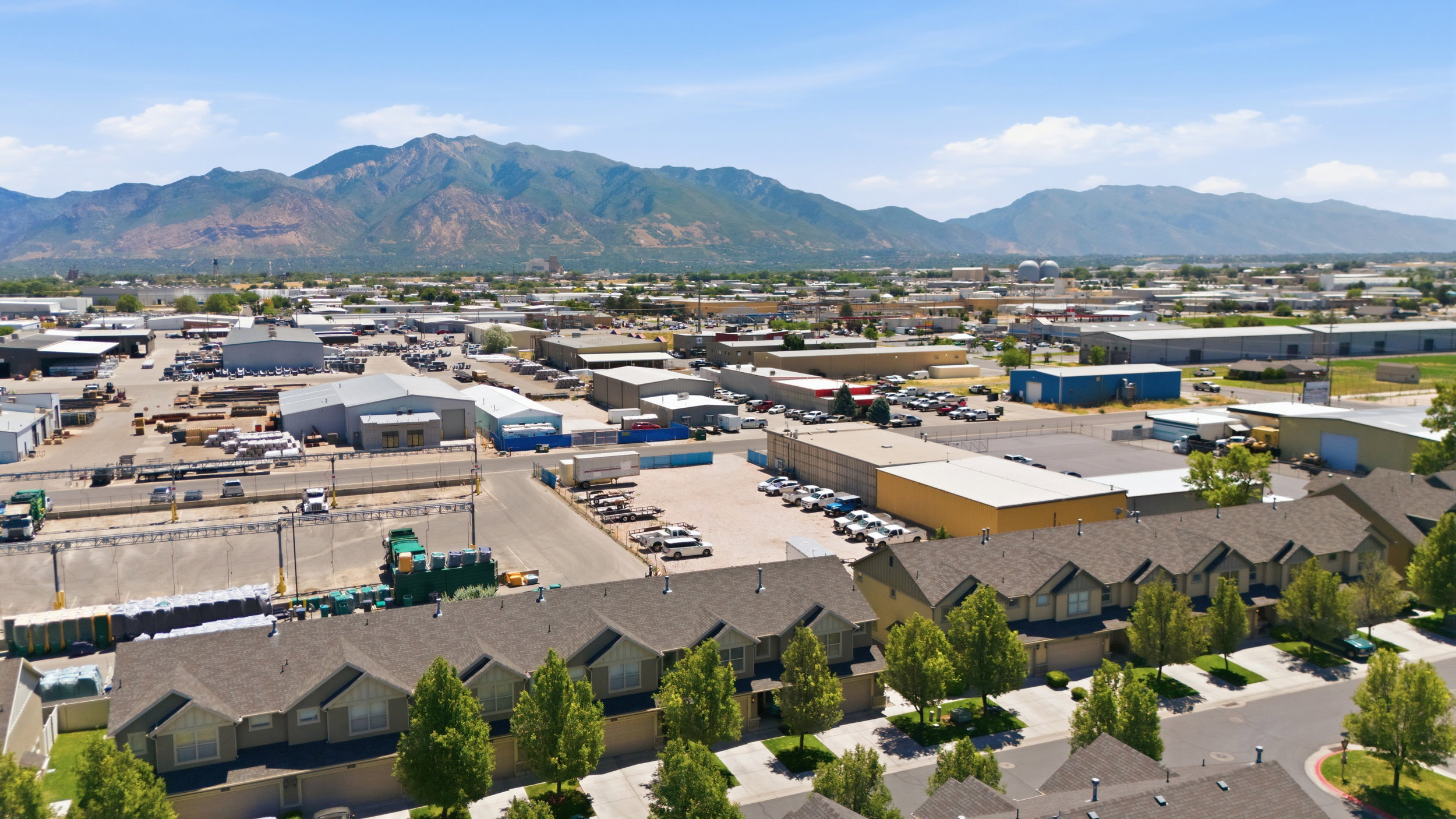 Aerial perspective showcasing a collection of properties with mountain scenery