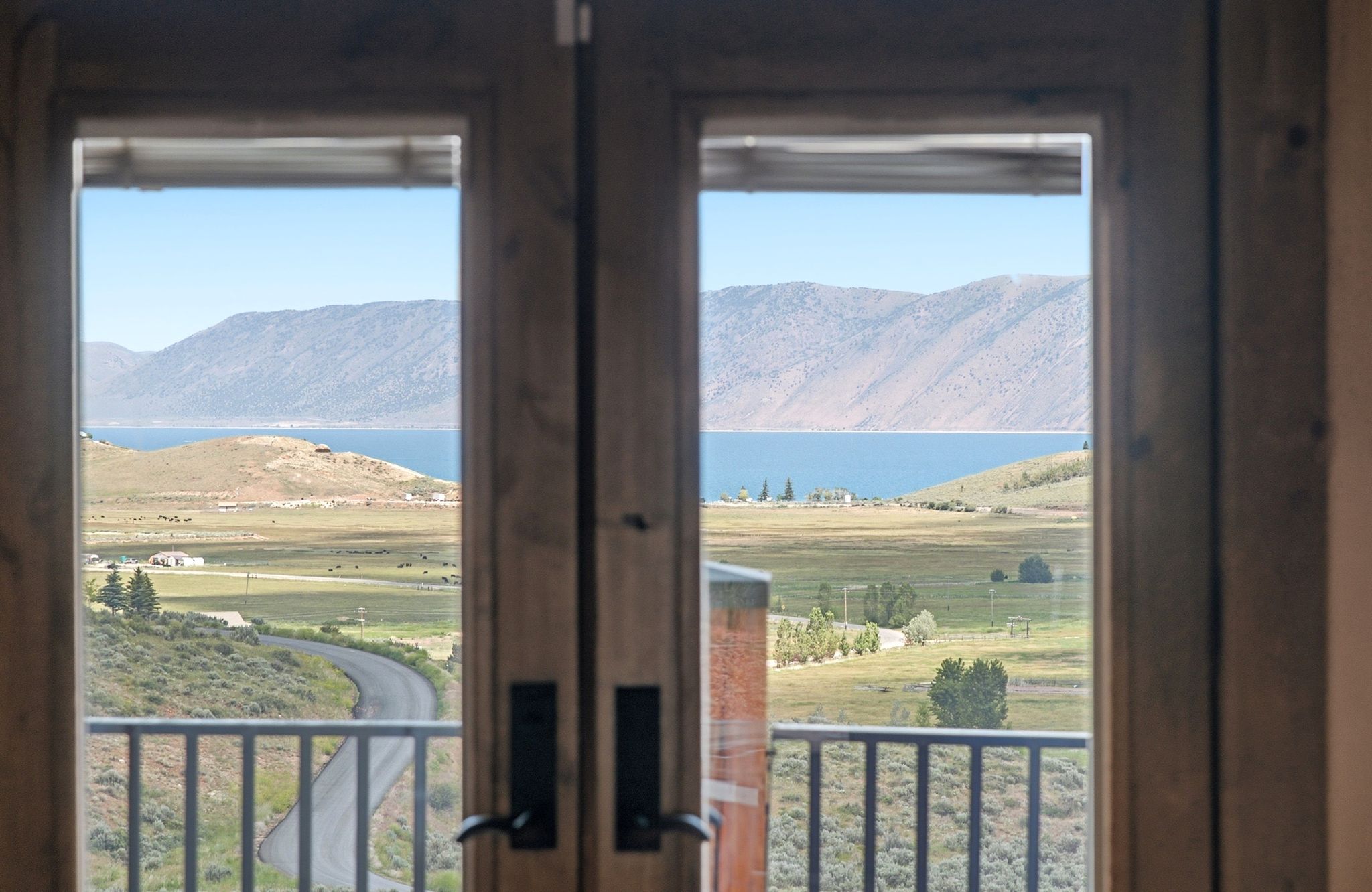 Double French doors opening to an exterior balcony with metal railings