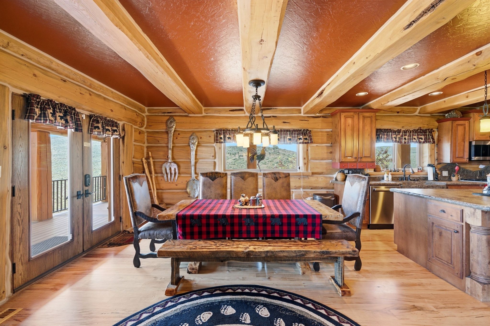 Exposed log walls and ceiling beams define this open-concept room
