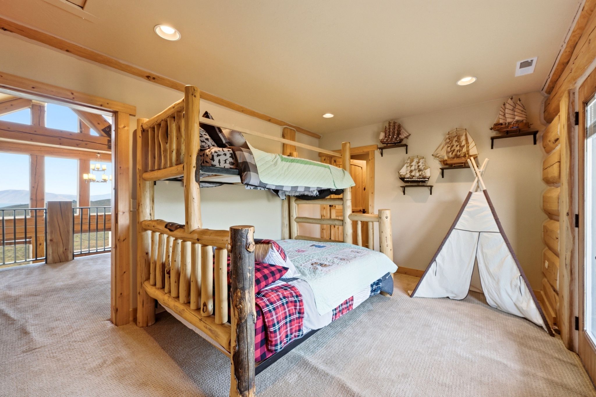 Carpeted room featuring a rustic log bunk bed, recessed lighting, and natural wood trim throughout