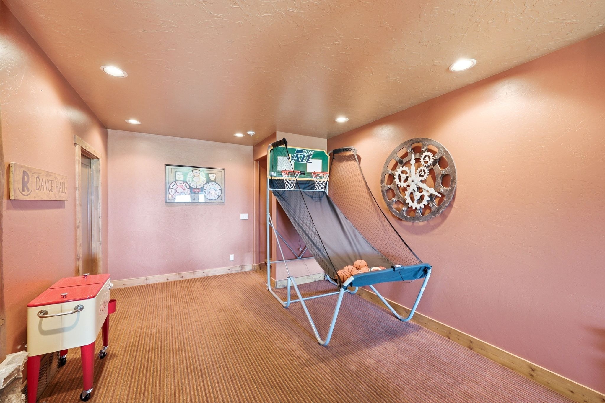 Spacious room featuring recessed lighting and striped carpet flooring