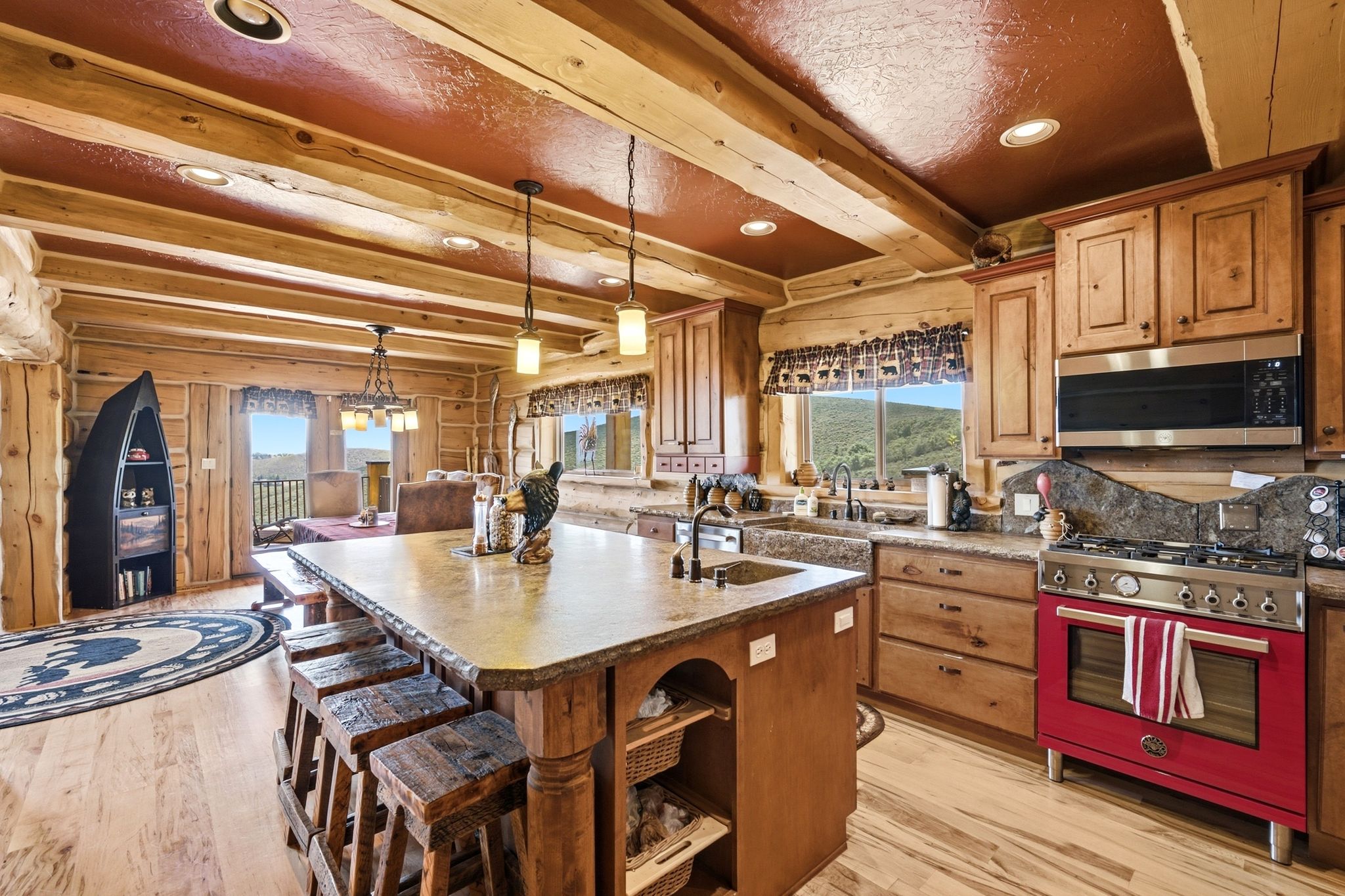 Spacious kitchen featuring a large central island with seating, a professional-grade range, wood cabinetry, and recessed lighting