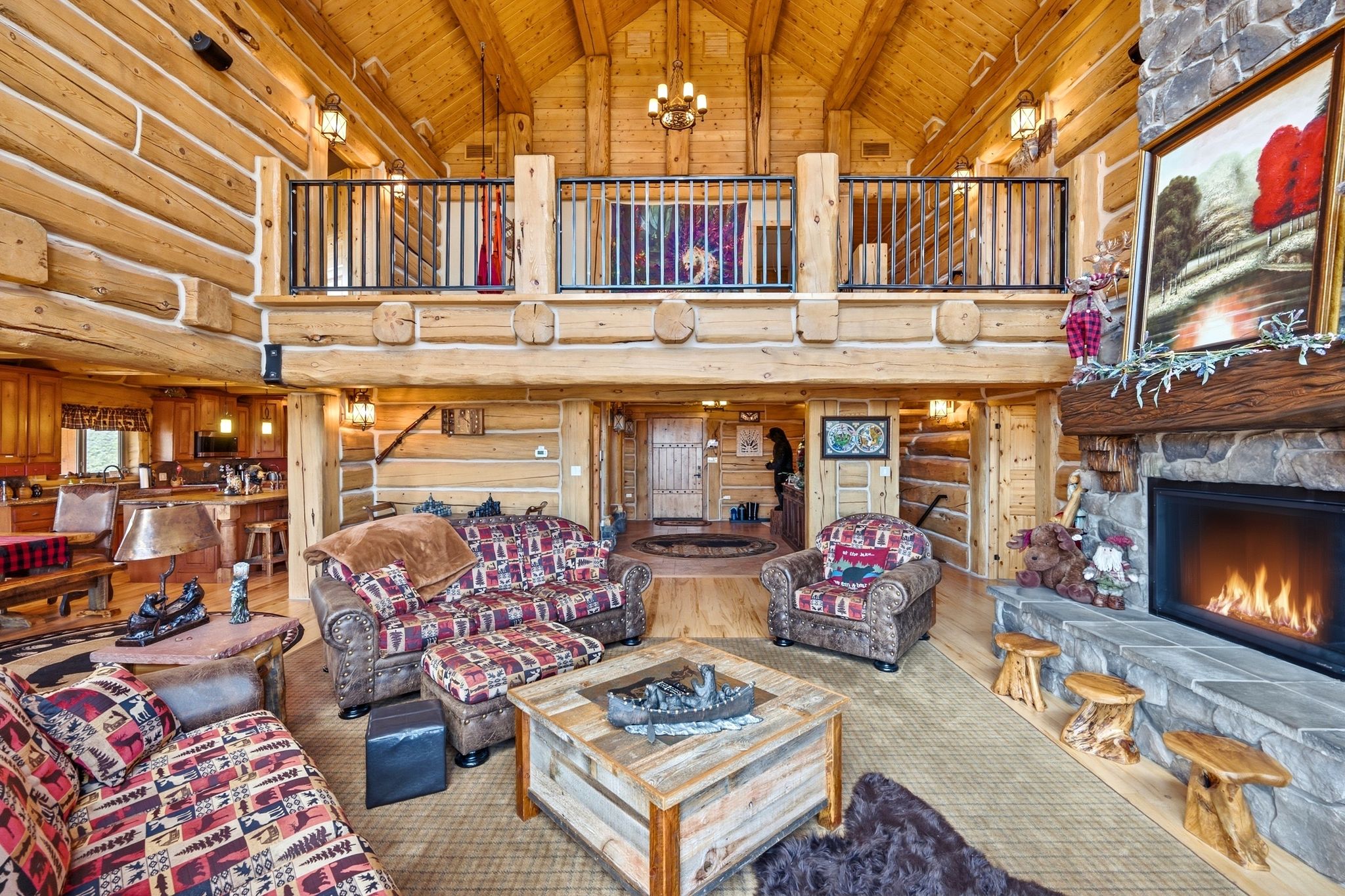 Two-story living area with exposed log walls and vaulted ceilings