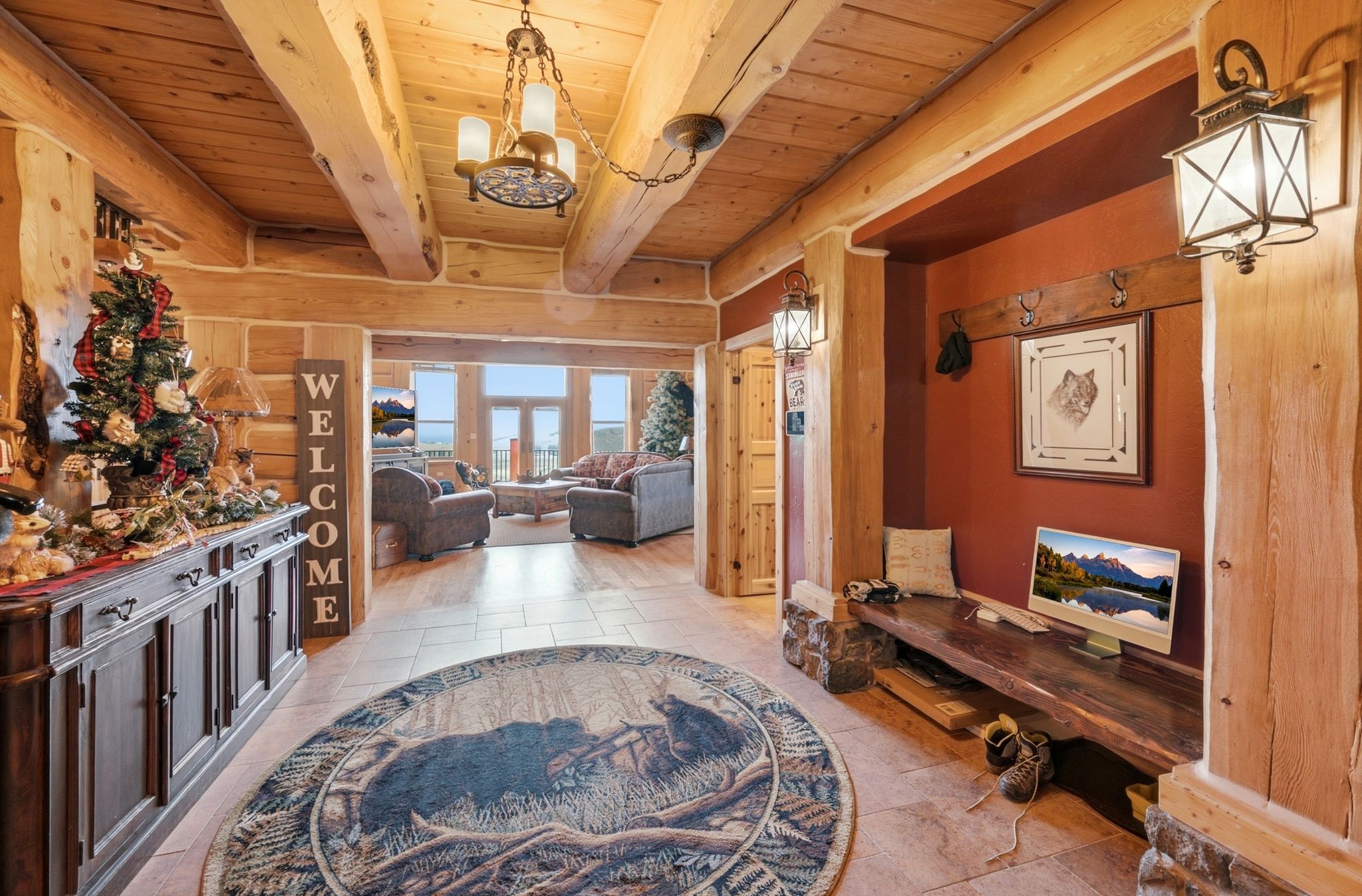Open concept interior featuring exposed log beams and wood-finish flooring