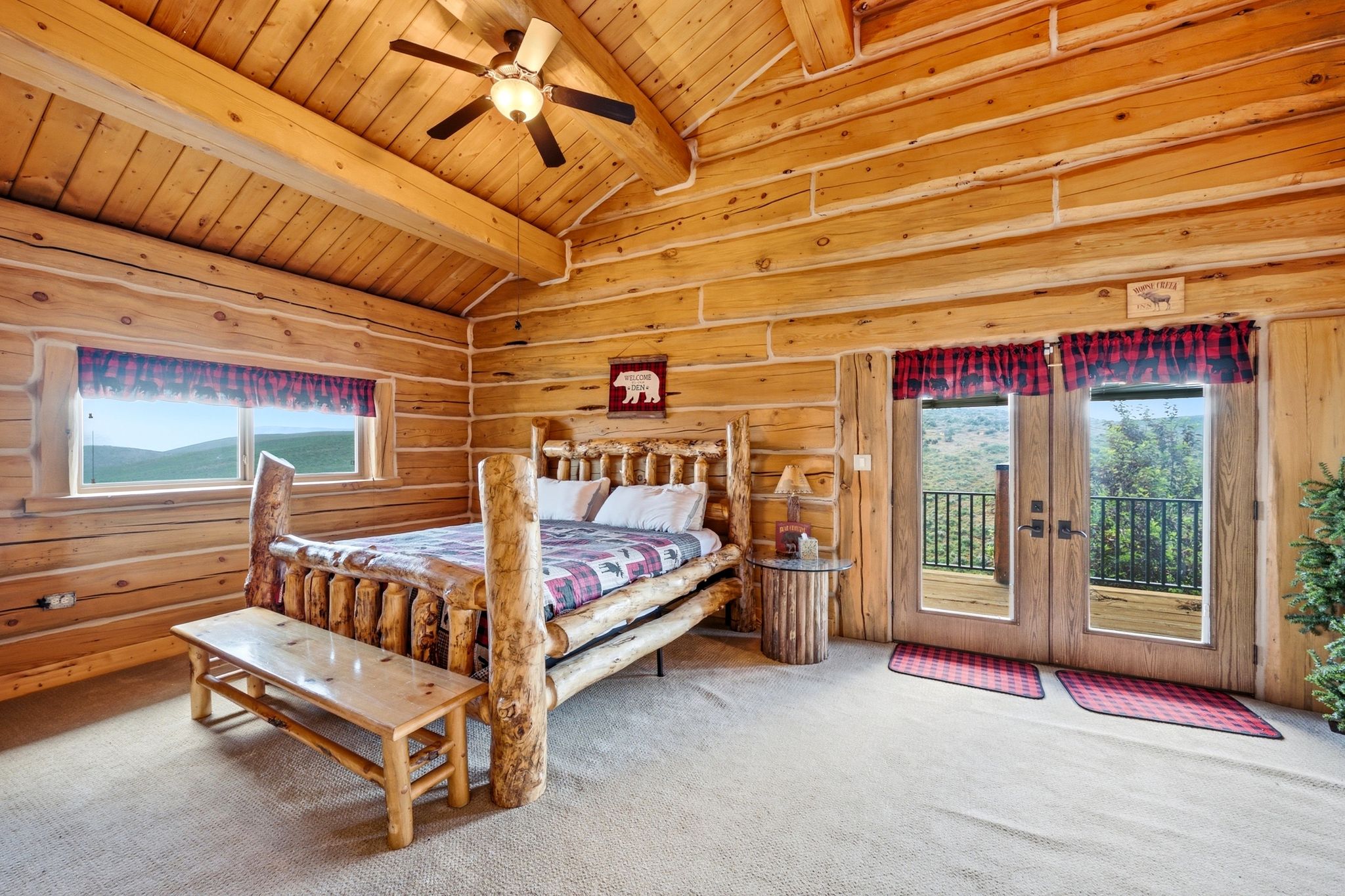 Rustic log cabin interior featuring exposed log walls and ceilings