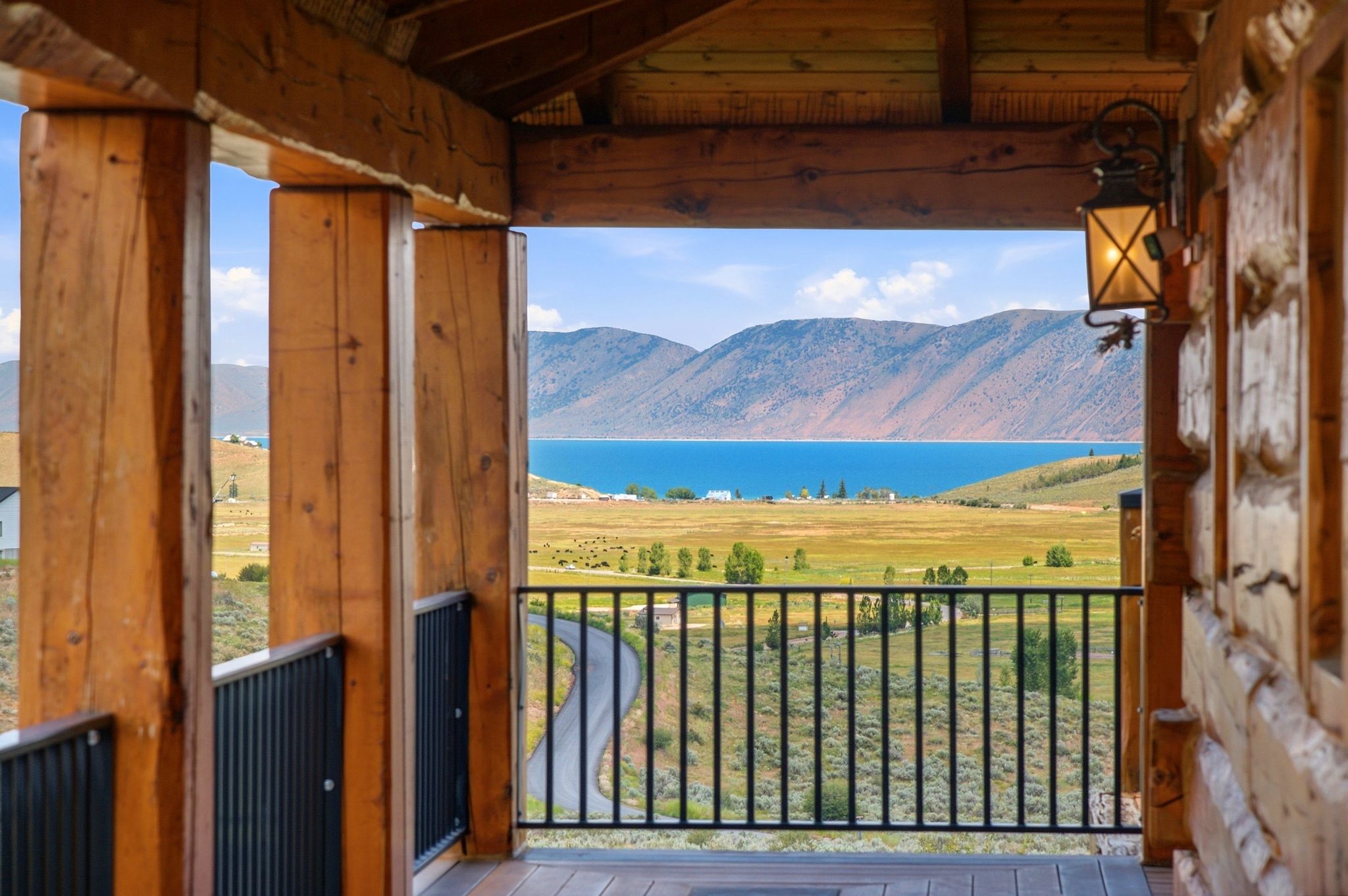 Expansive balcony featuring robust wood structural beams and a black metal railing