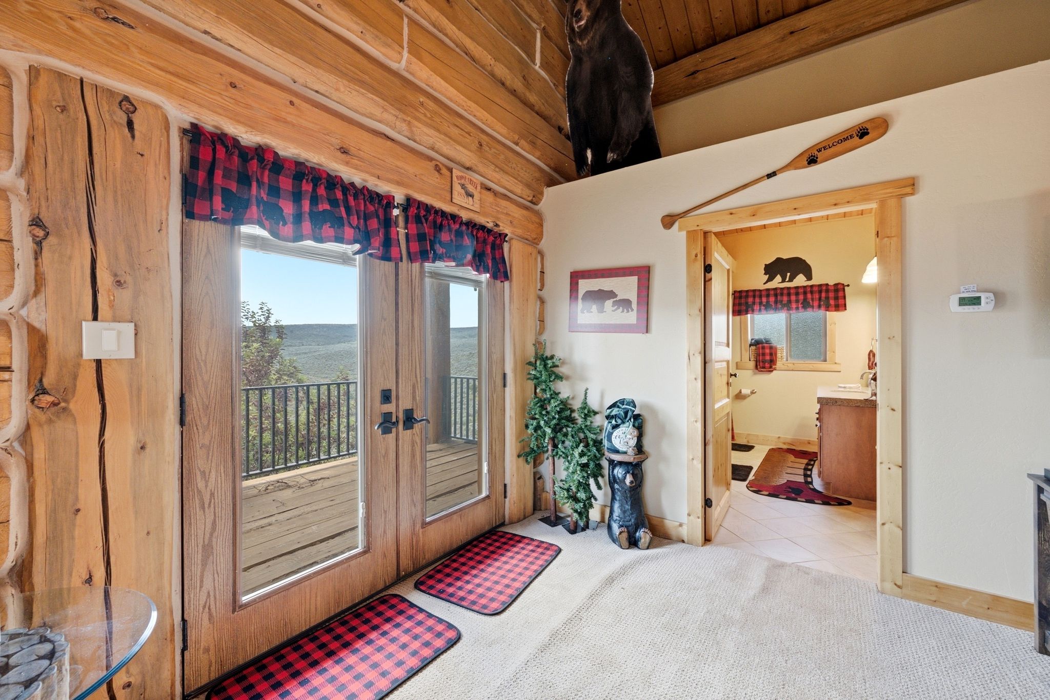 Double-door balcony access featuring wood frames and black hardware