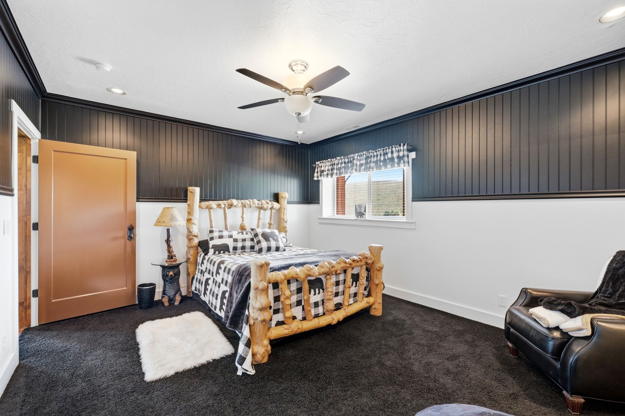 Room featuring dark carpet flooring and a ceiling fan with integrated lighting