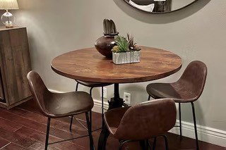 Wood-finish flooring paired with light-toned wall paint and an accent mirror