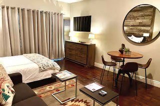 Compact living area featuring wood-finish flooring, light-toned walls, and recessed lighting
