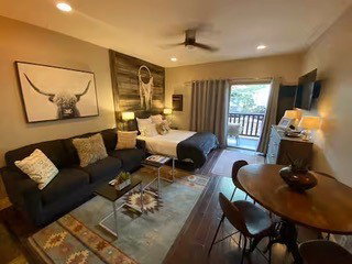 Open-concept studio space featuring wood-finish flooring, recessed lighting, and a ceiling fan