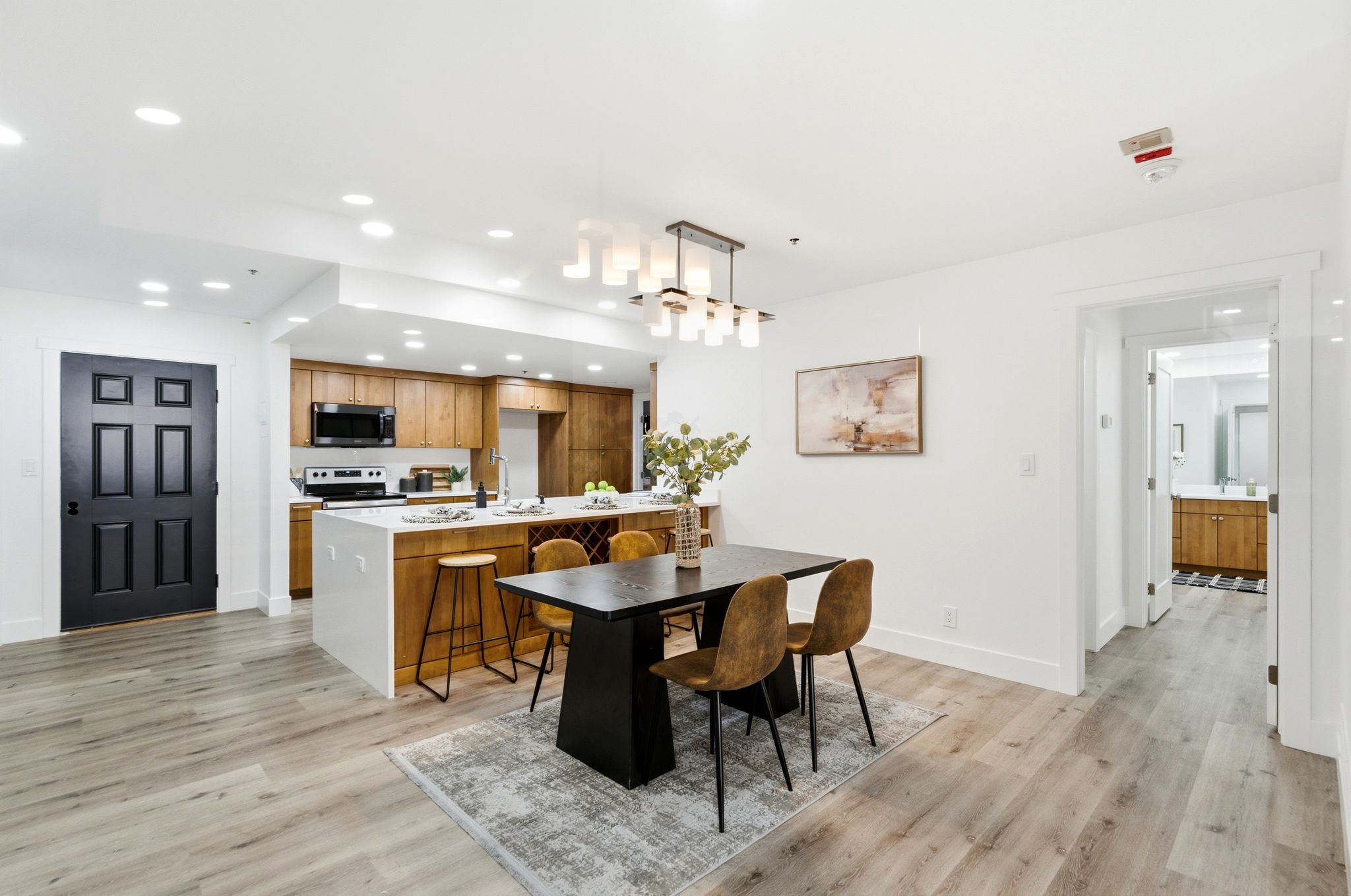 Modern open-concept living space with wood-finish flooring throughout