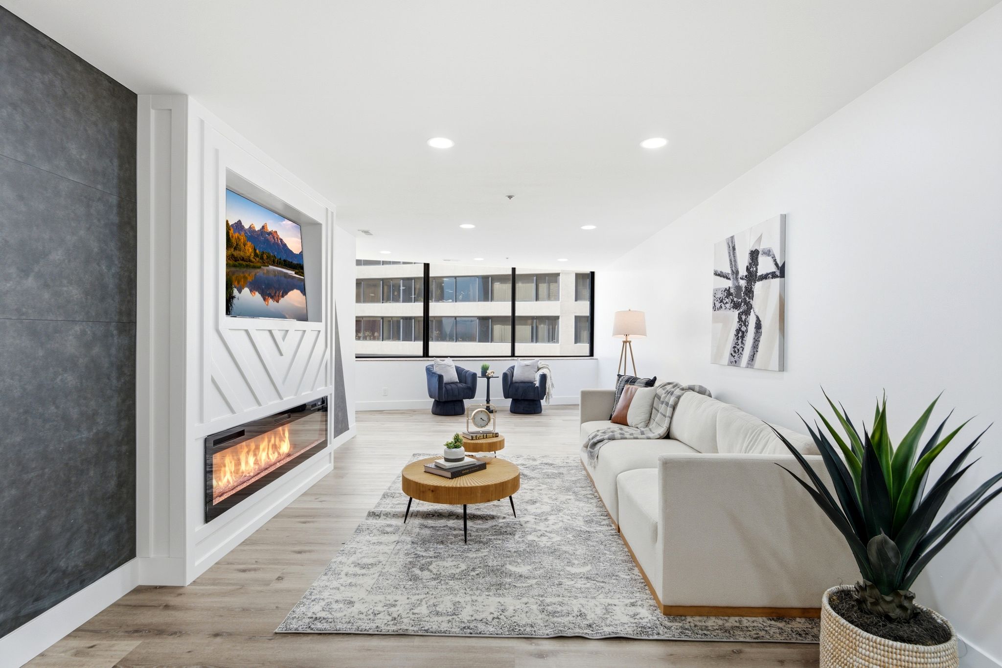 Living space featuring a built-in media wall with an electric fireplace, recessed lighting, and light wood-finish flooring