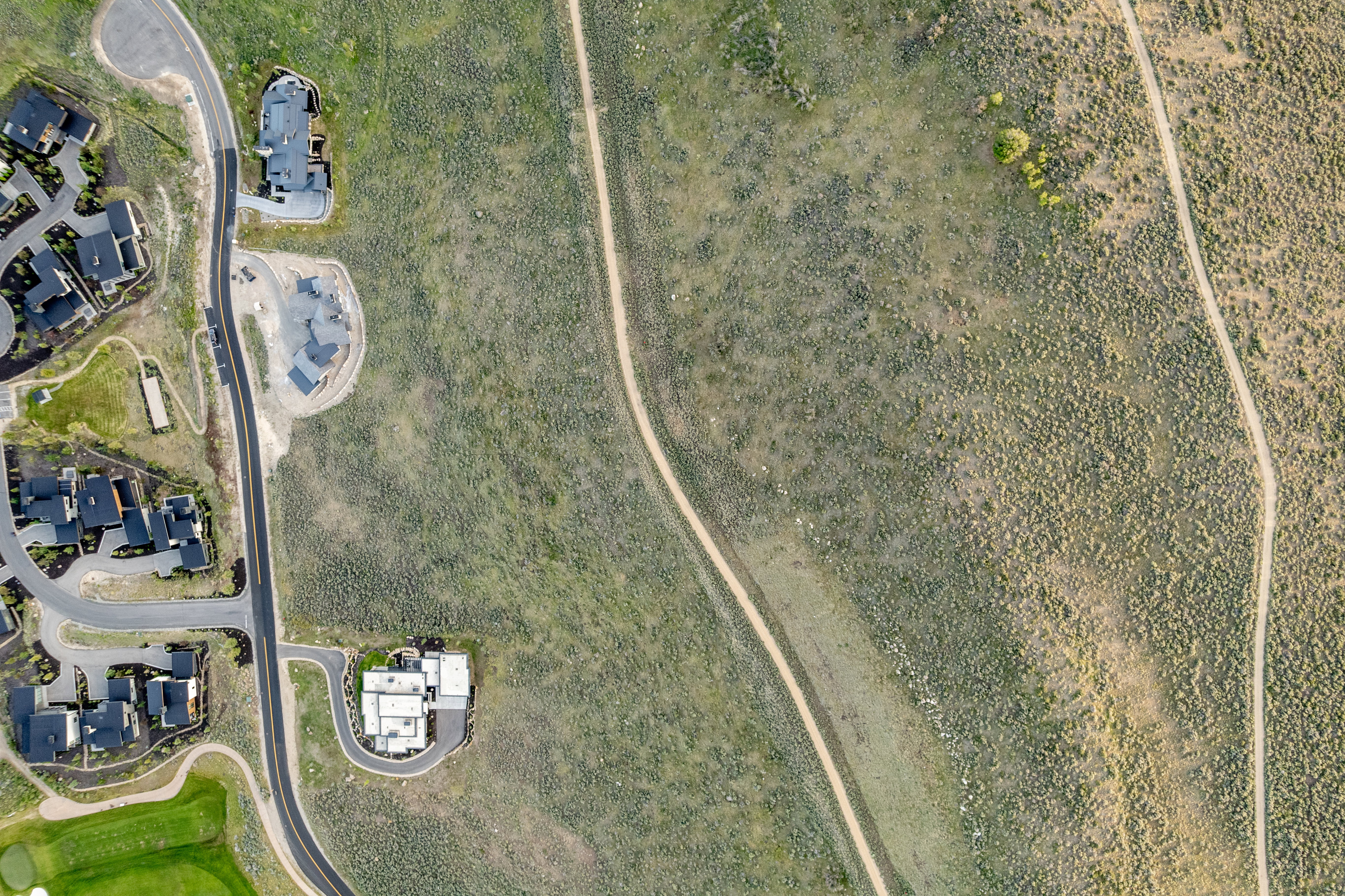 Aerial representation of residential development featuring paved roads and multiple structures