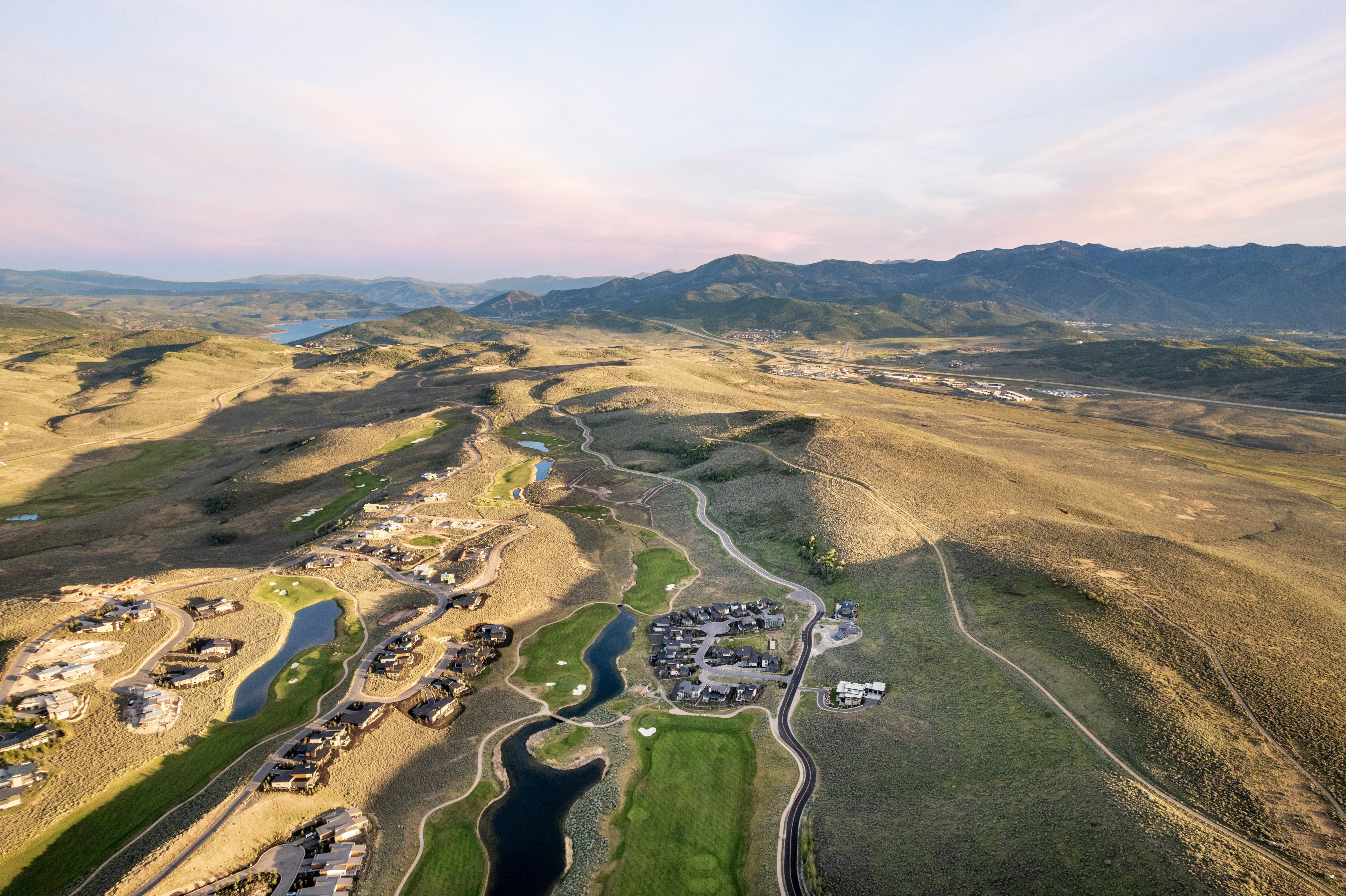 Aerial perspective showcasing a residential community integrated with a golf course