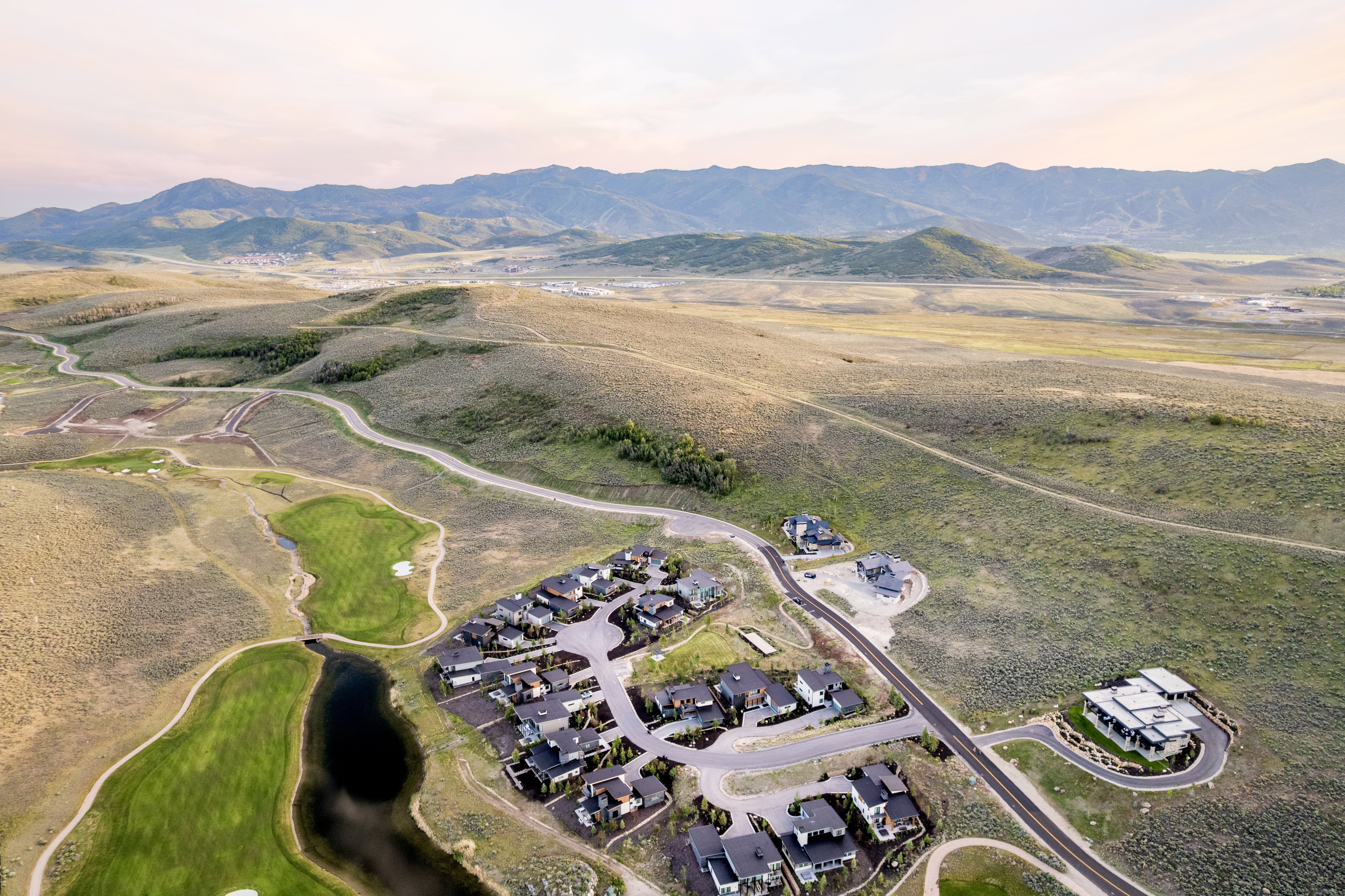 Aerial perspective showcasing a residential development nestled within a mountainous landscape