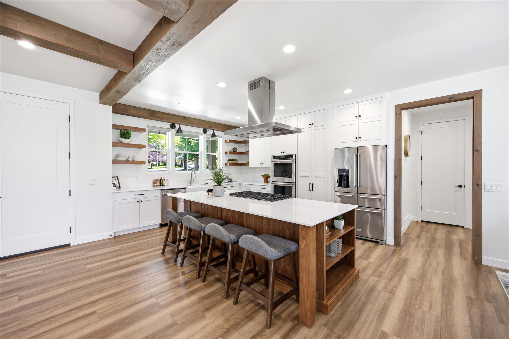 Spacious kitchen featuring wood-finish flooring and exposed beam ceiling