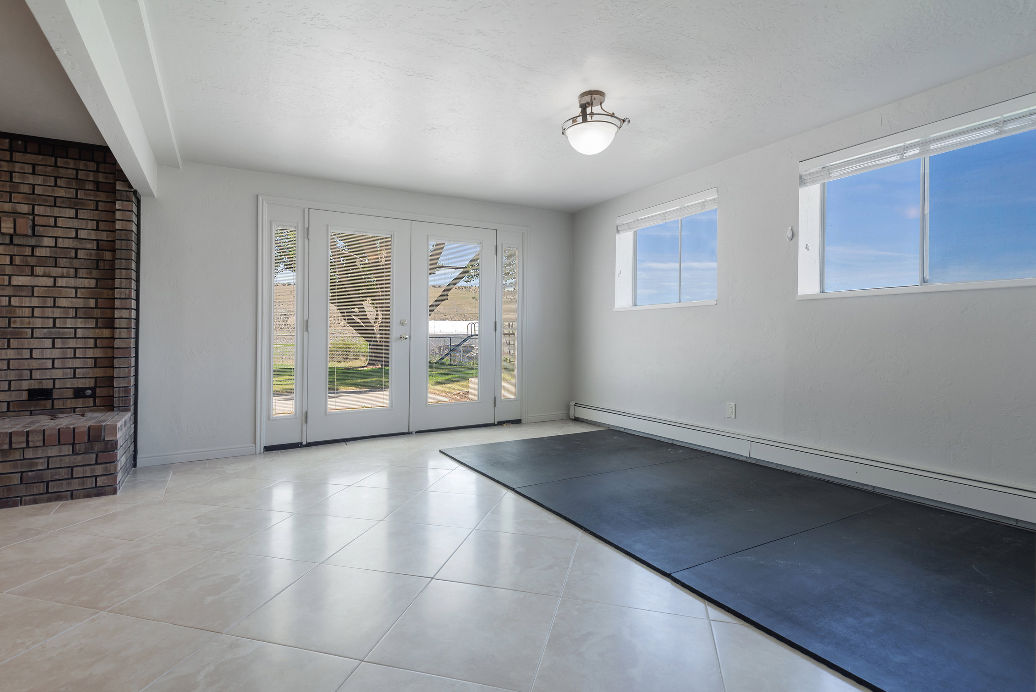 Tile flooring complemented by a brick fireplace with hearth