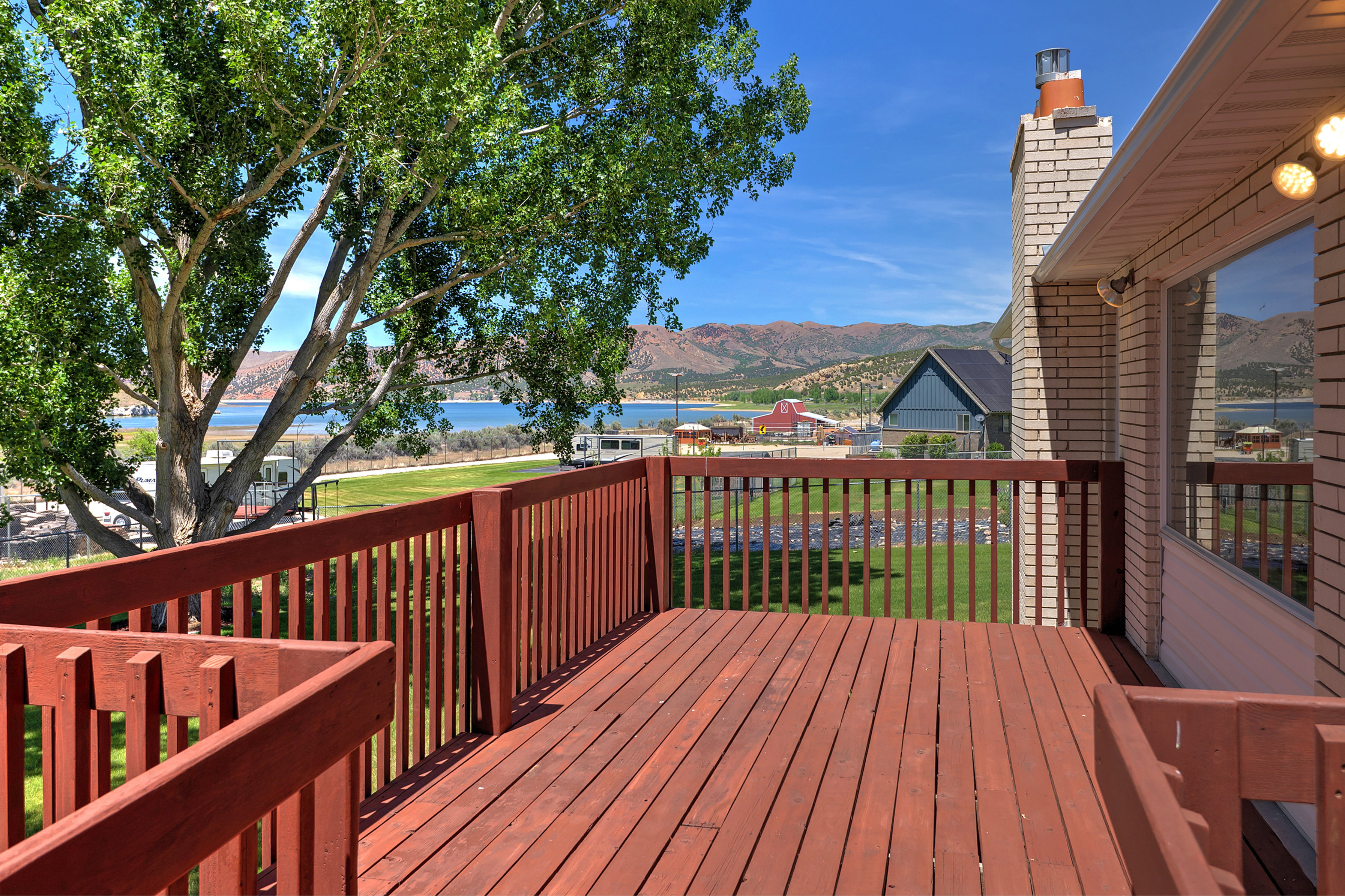 Expansive exterior deck with wood-finish flooring and railings