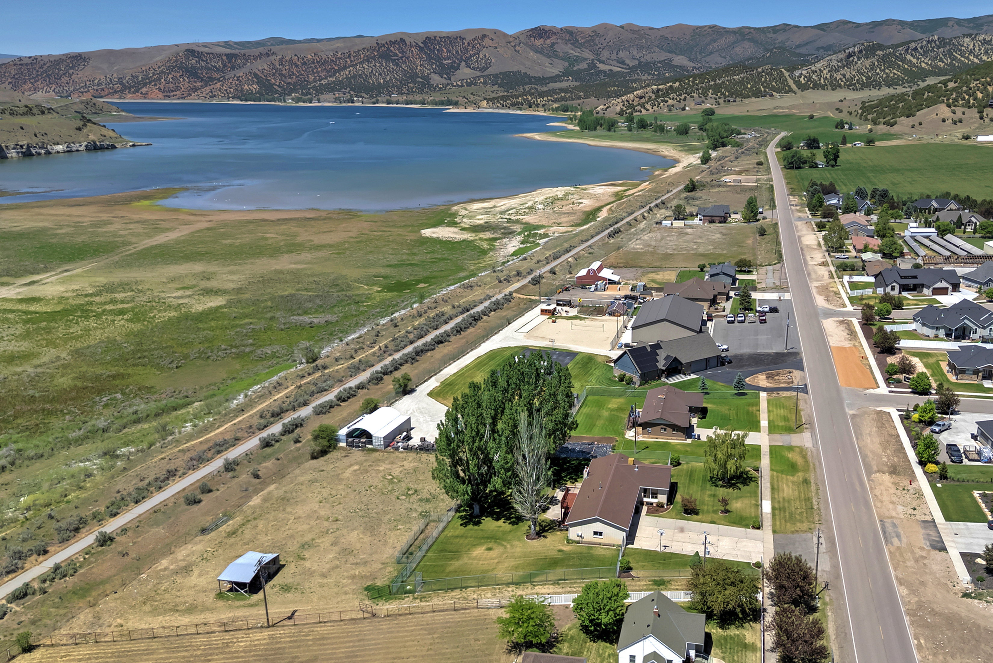 Expansive aerial showcasing a body of water framed by distant mountains and a residential area