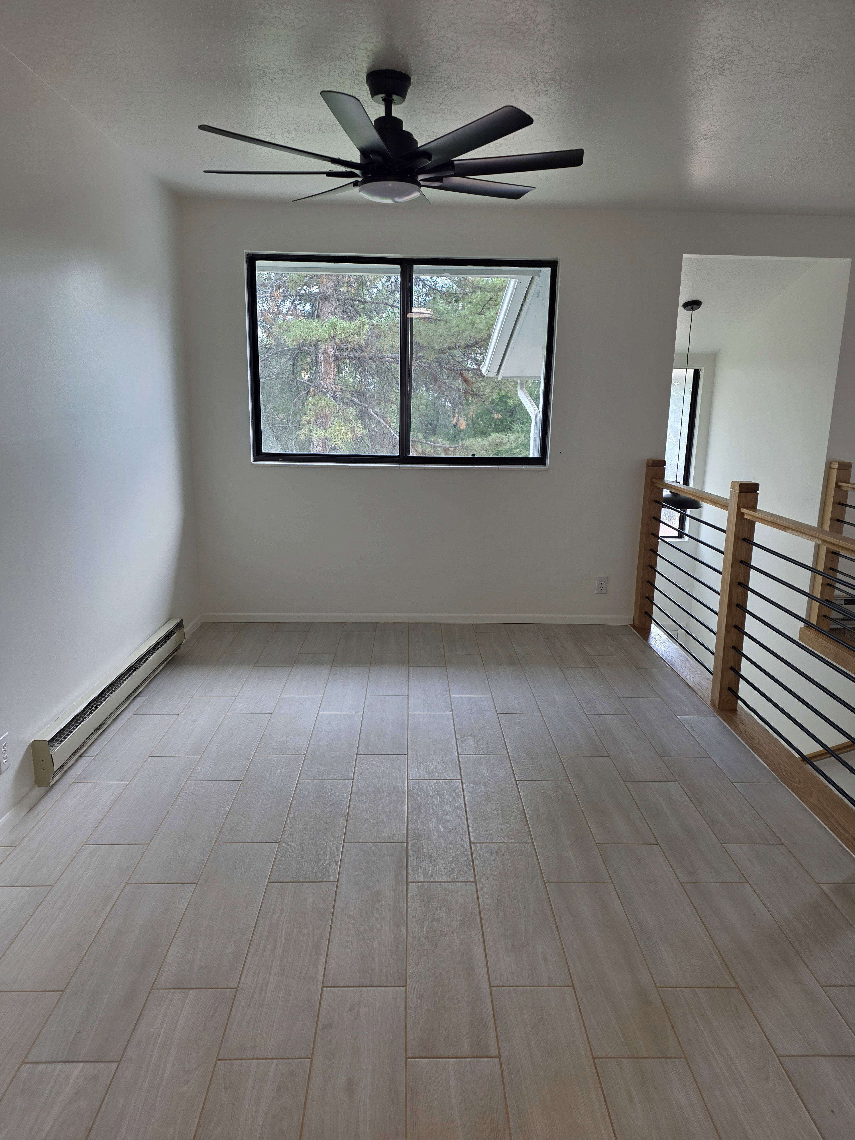 Dining room with new tile flooring and ceiling fan.