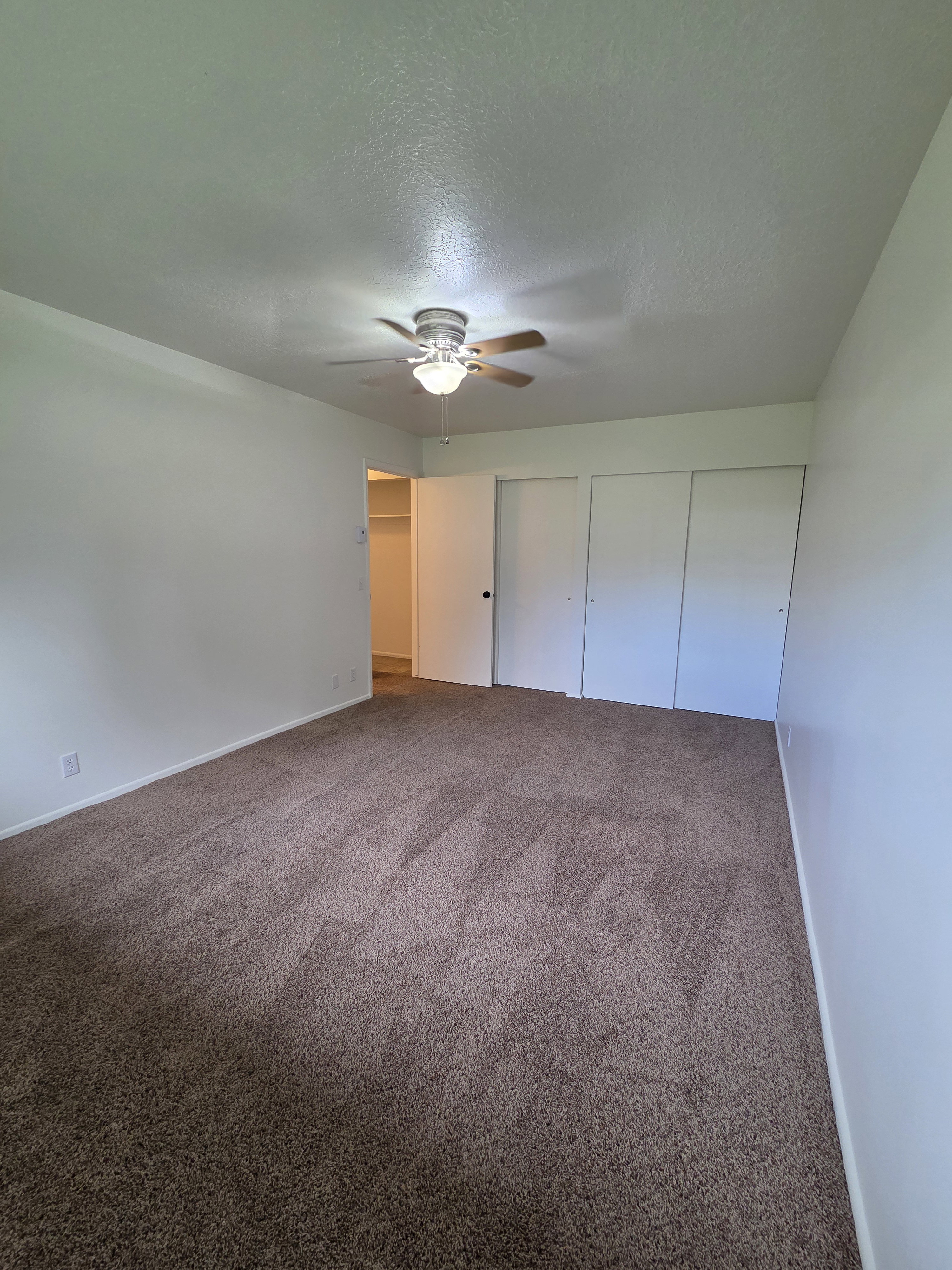 Primary bedroom with his and her closets