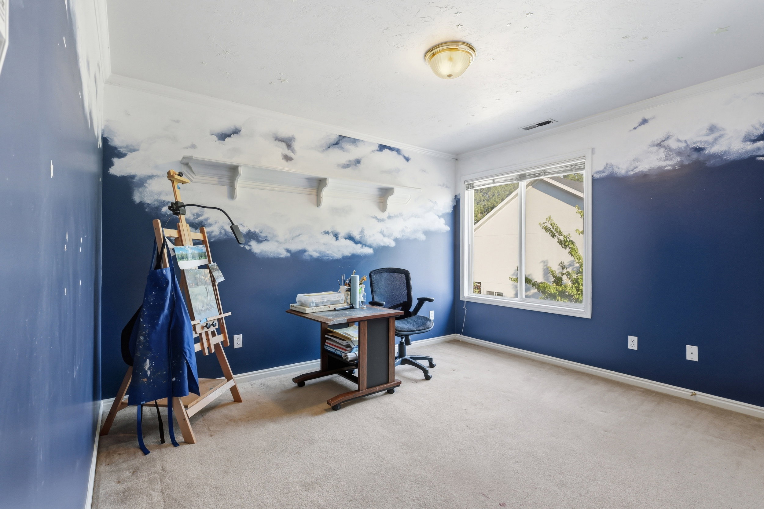 Spacious room featuring a large window, wall-to-wall carpeting, and crown molding