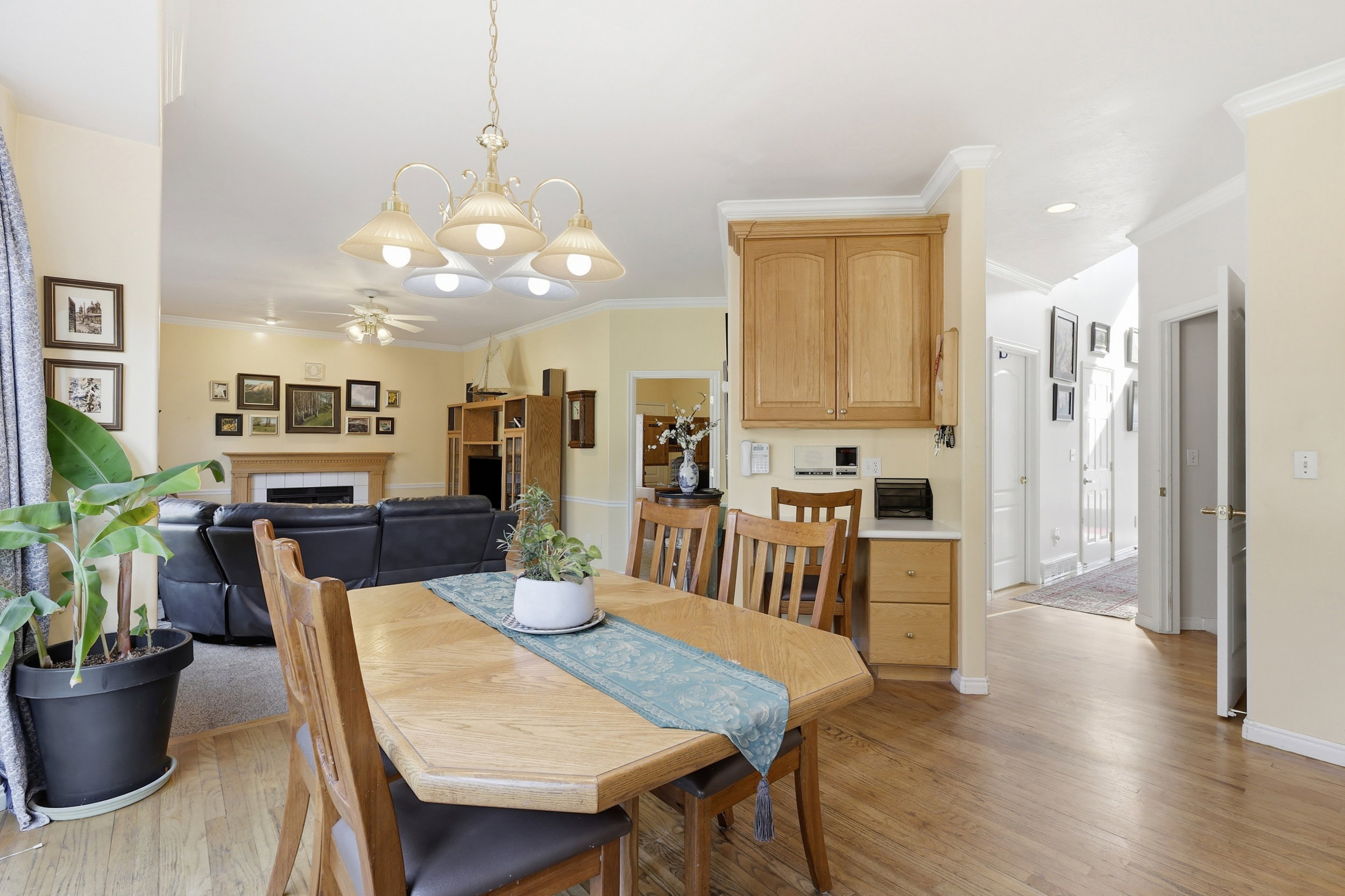 Dining area featuring wood-finish flooring, a decorative chandelier, and built-in cabinetry