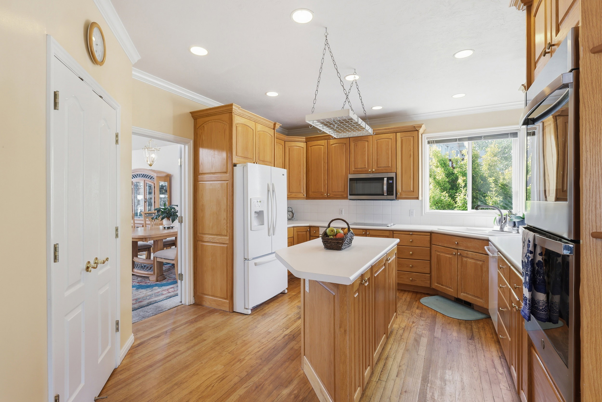 Kitchen featuring wood-finish flooring, recessed lighting, and a center island with a light-toned countertop