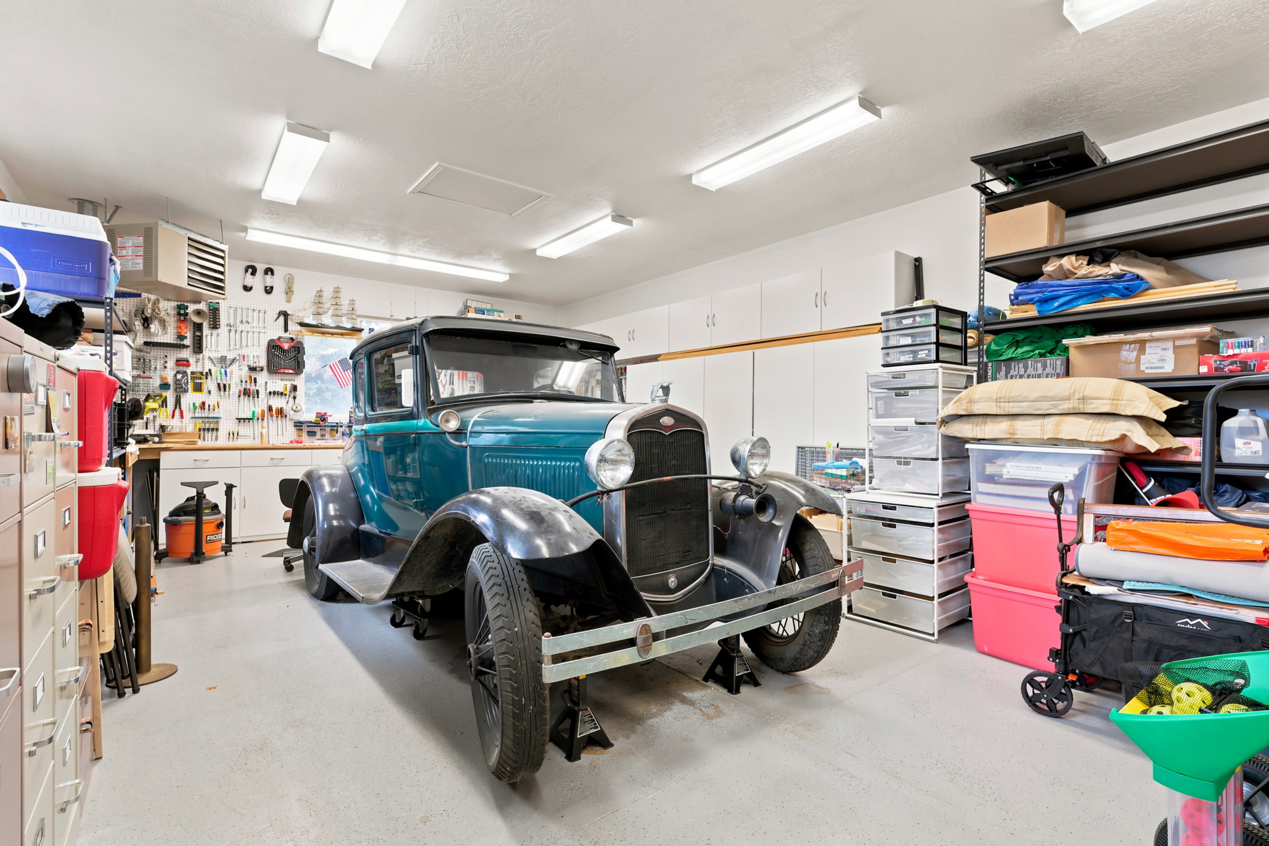 Spacious garage with light gray flooring and white walls