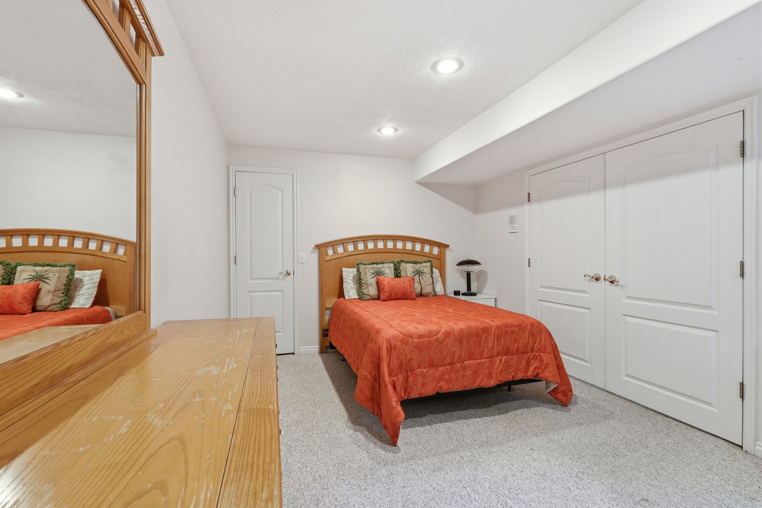 Bedroom with light-colored carpet flooring and white walls