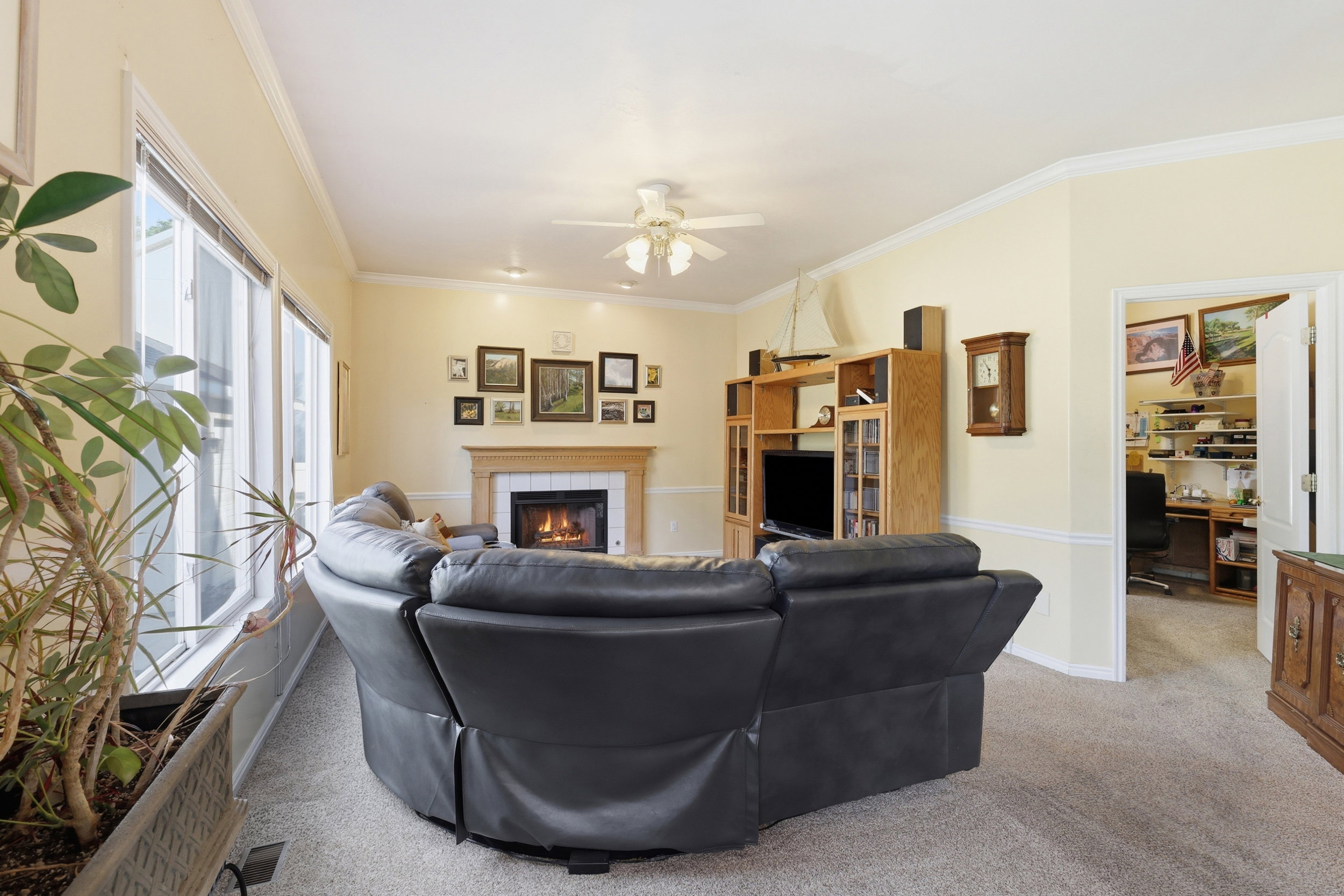Living area with a fireplace featuring a tile surround and wood mantel