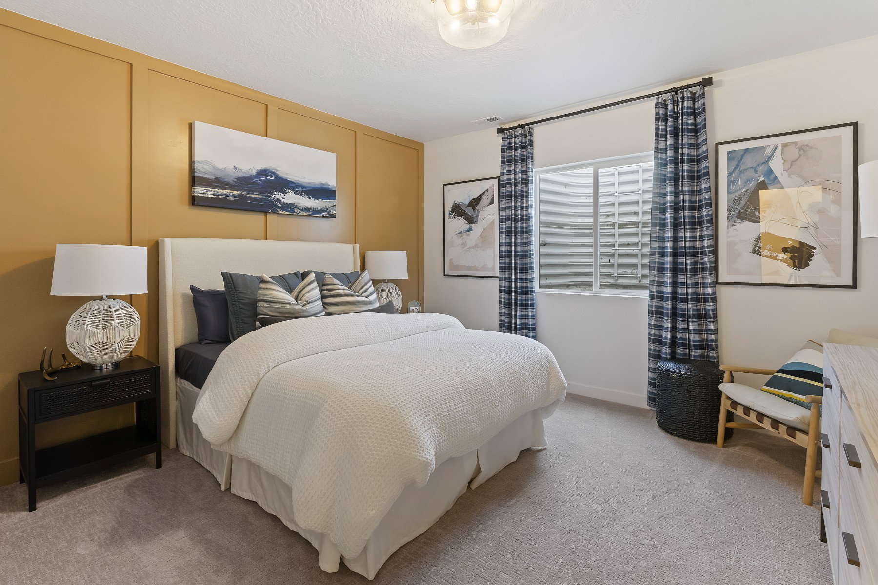 Bedroom featuring a decorative accent wall, light-colored carpeting, a window with a window well, and an overhead light fixture
