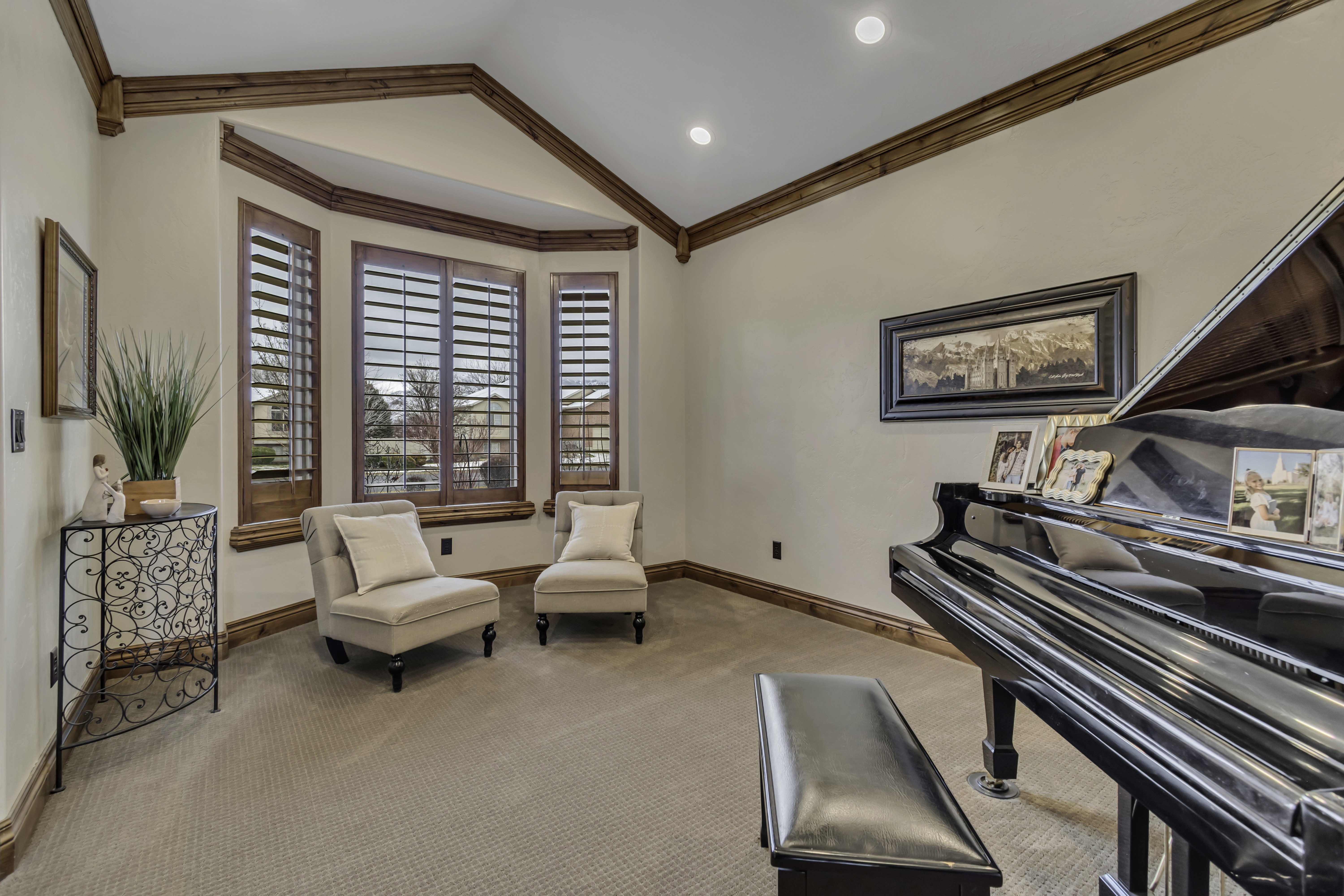 Bay window with custom wood plantation shutters, complemented by wood trim and ceiling beams