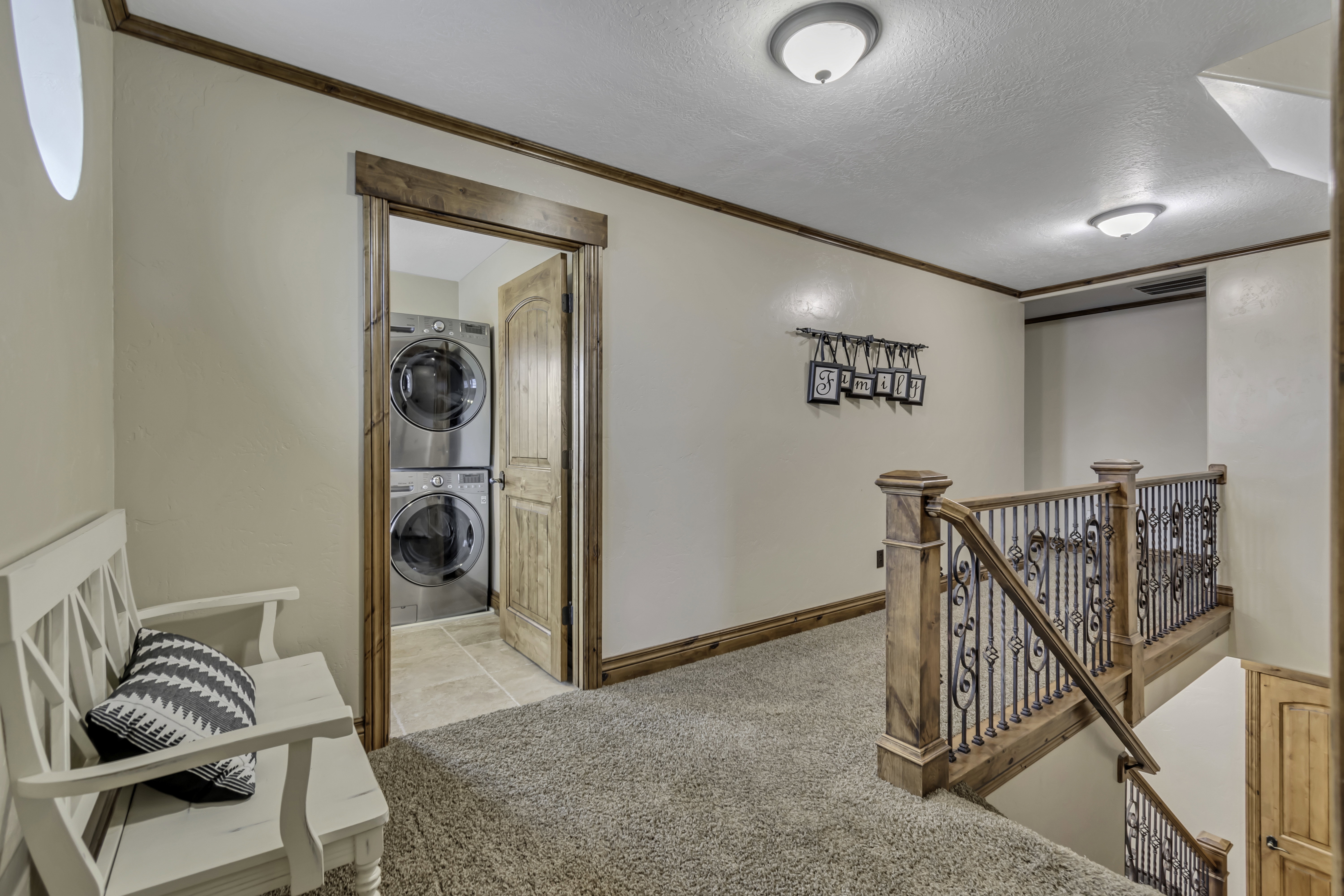 Upper-level landing featuring wood trim accents and a carpeted floor