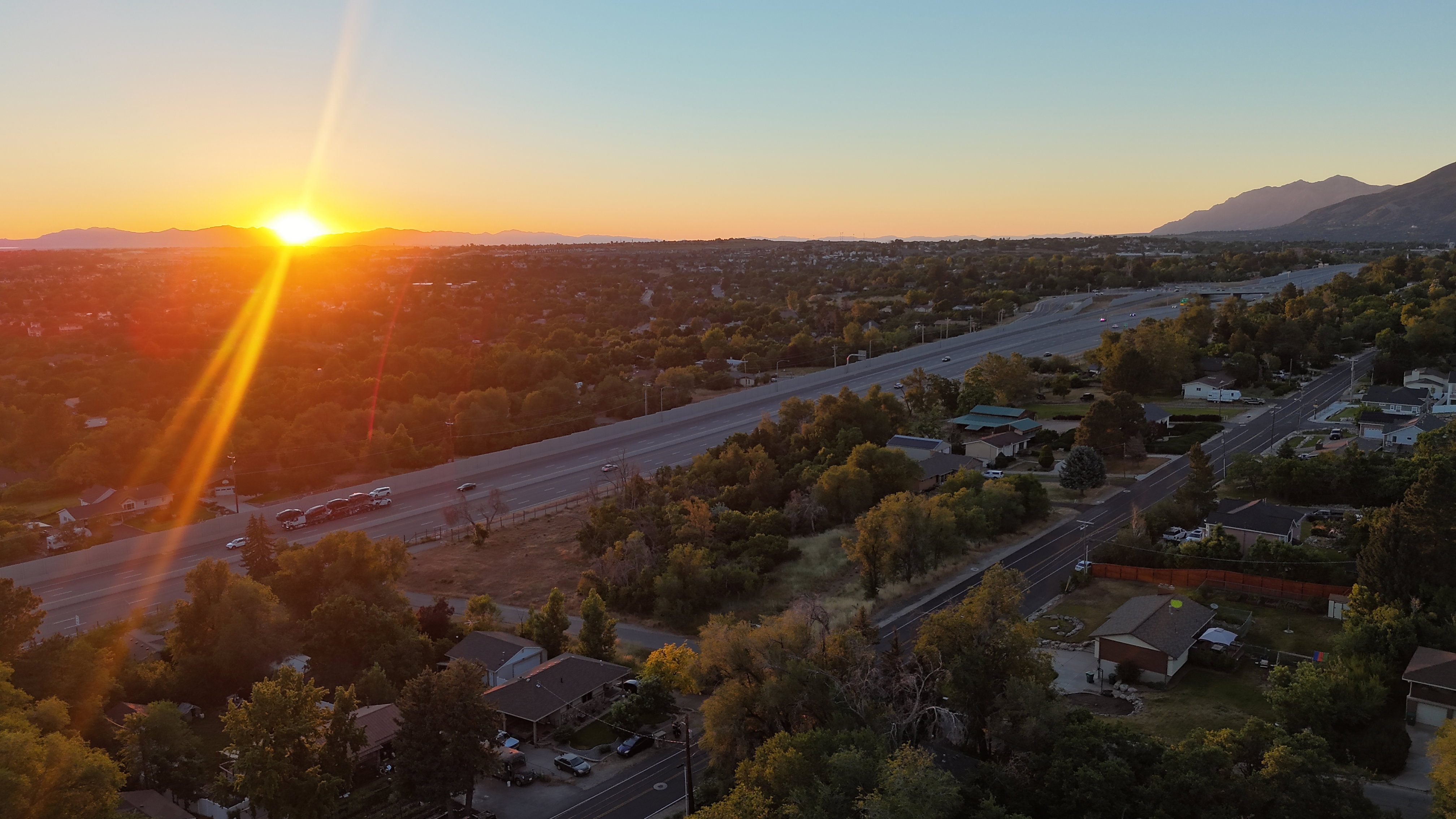 Aerial perspective showcasing a residential area with extensive tree coverage
