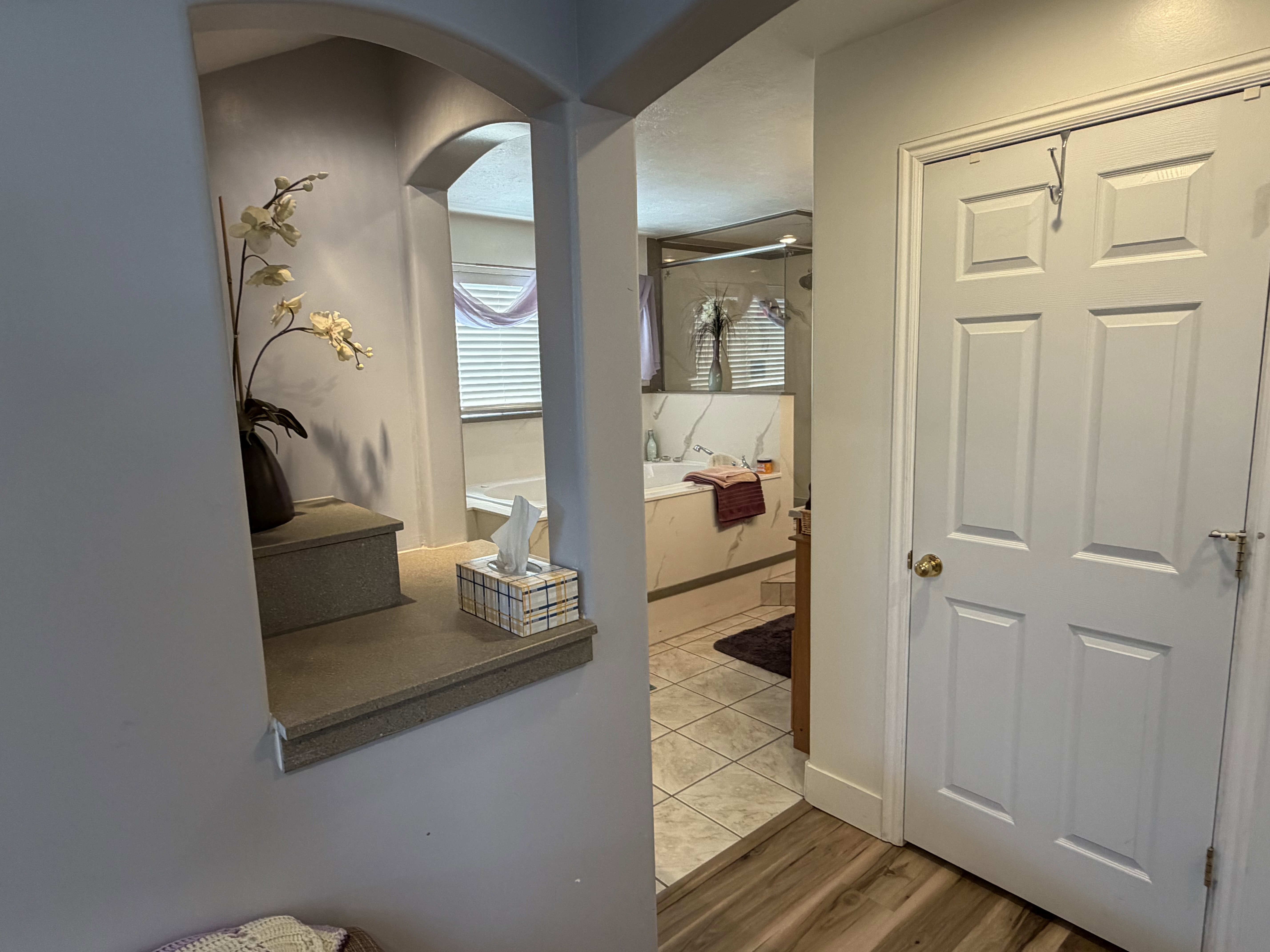 Archway featuring a recessed display niche with tiered shelving