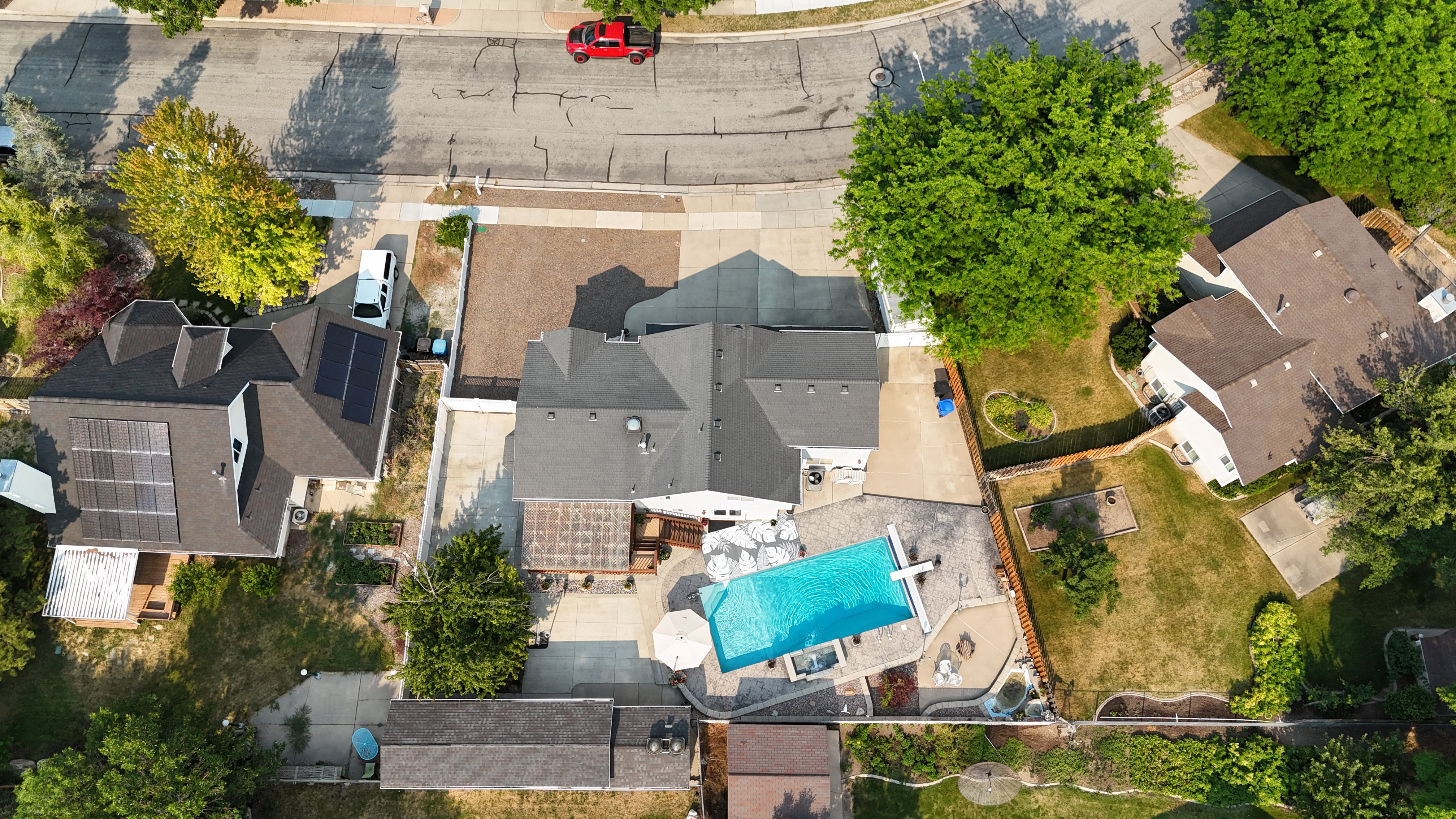 Outdoor living space featuring a rectangular swimming pool, integrated spa, and expansive paver patio