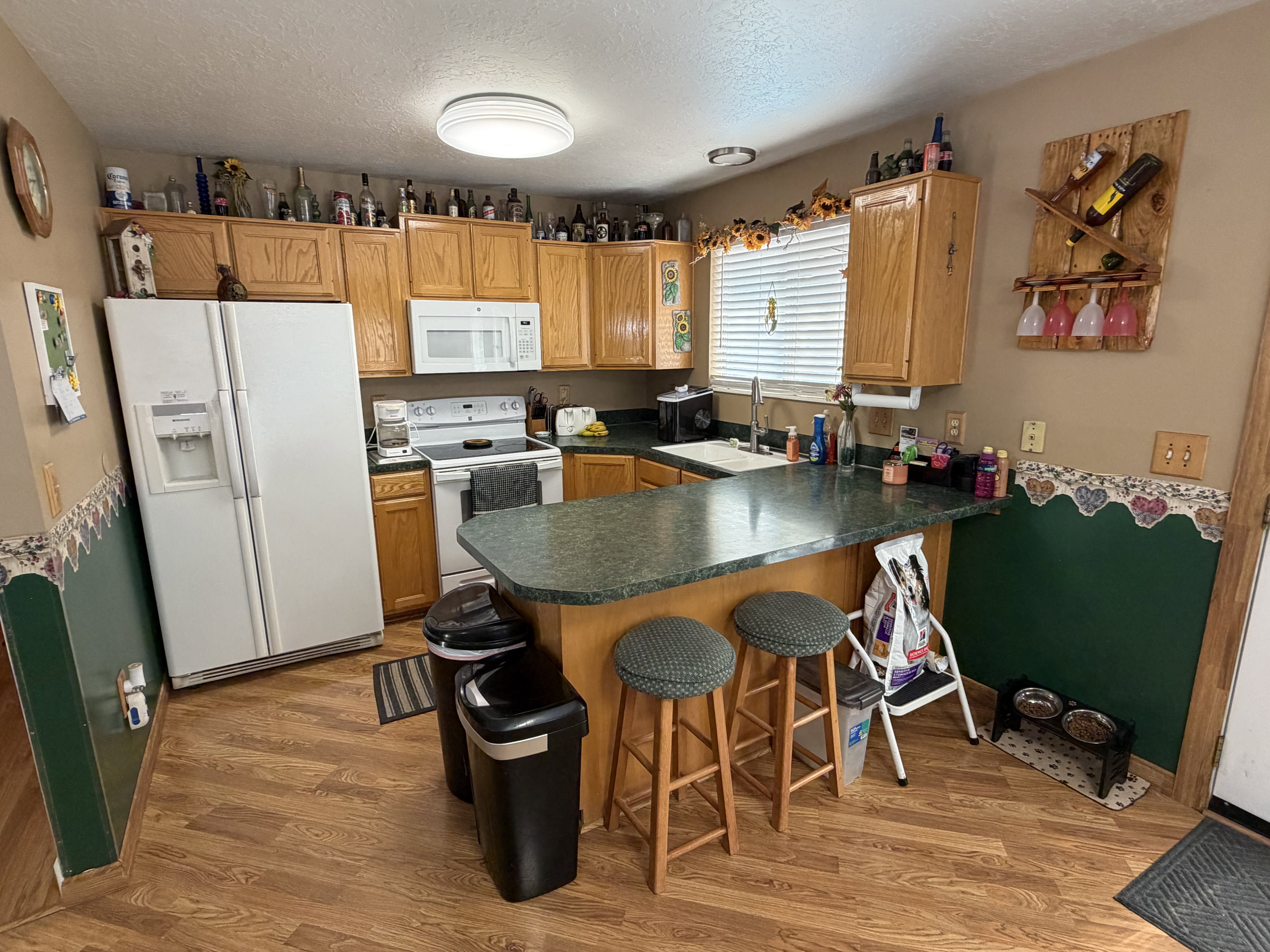 Kitchen featuring wood-finish flooring and oak cabinetry