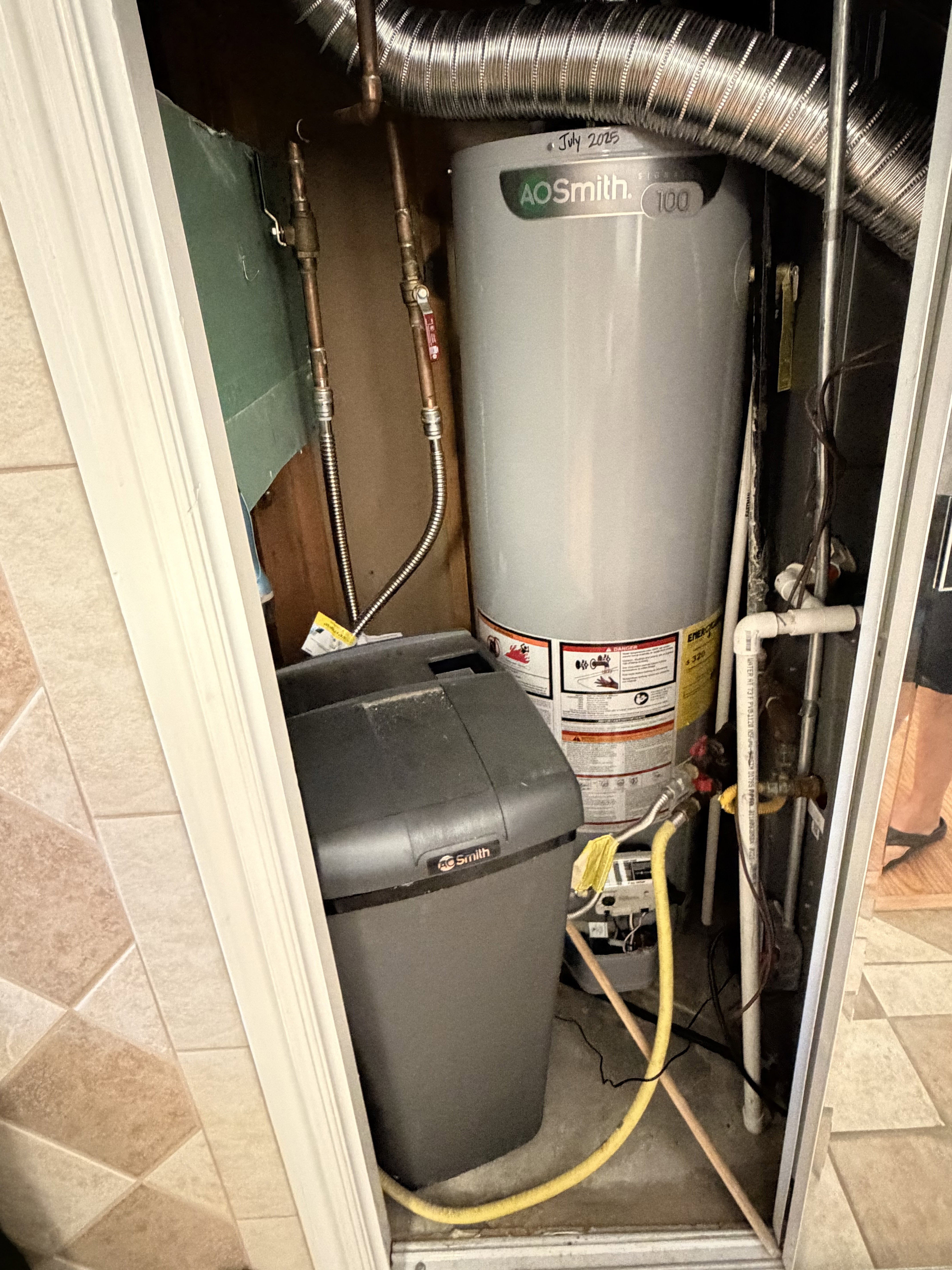 AO Smith water heater with visible copper piping and flexible ductwork