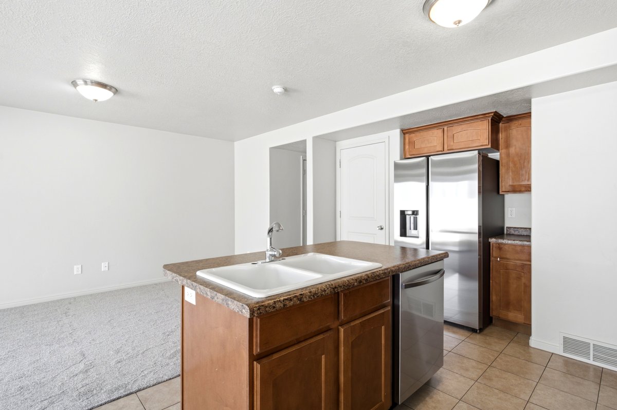 Kitchen island with double basin sink and stainless steel faucet