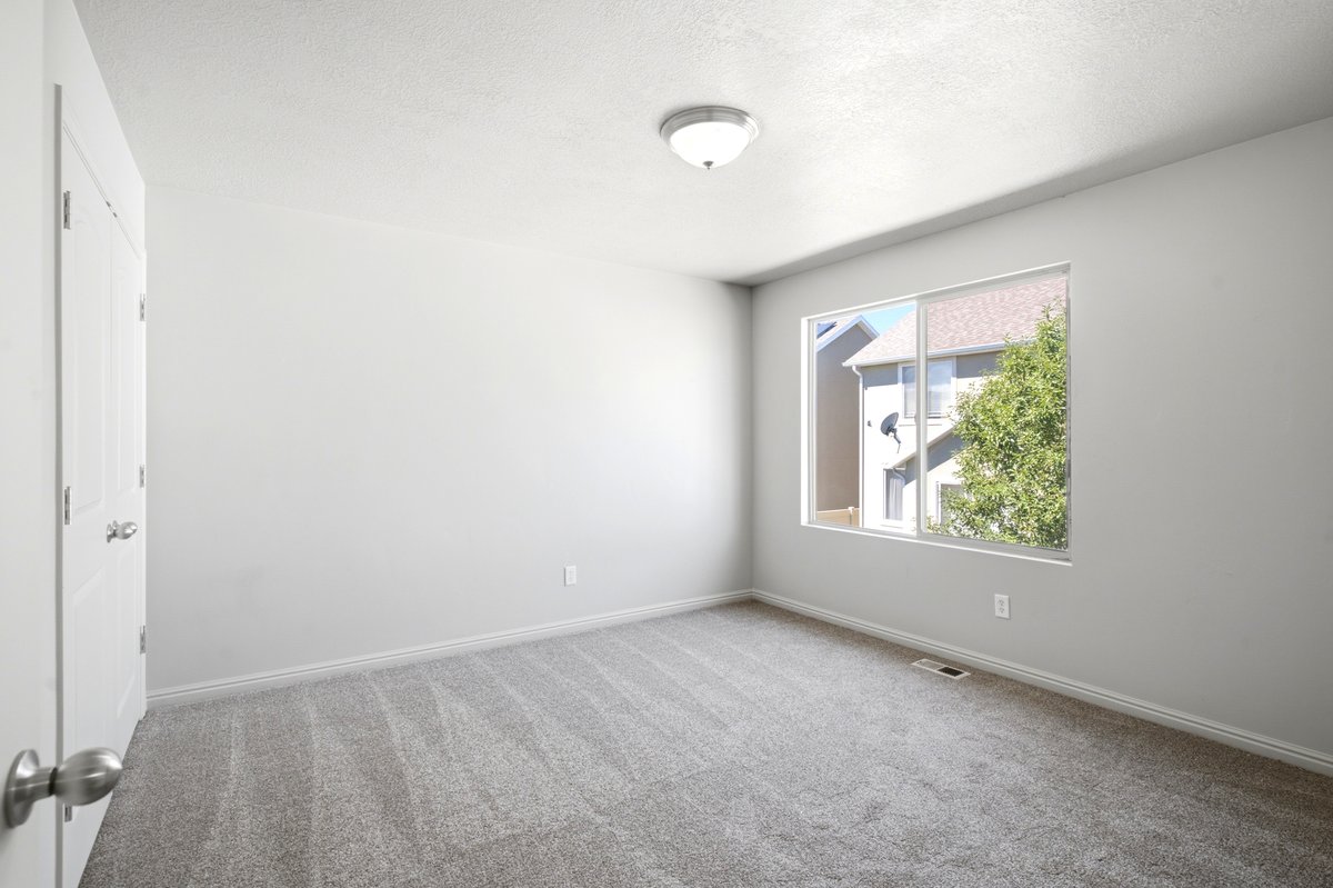 Neutral painted walls and grey carpet flooring